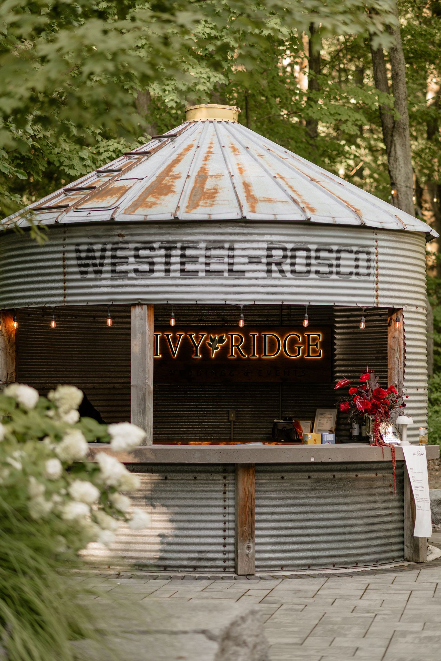 Rustic metal venue signs reading Ivy Ridge with corrugated steel design.