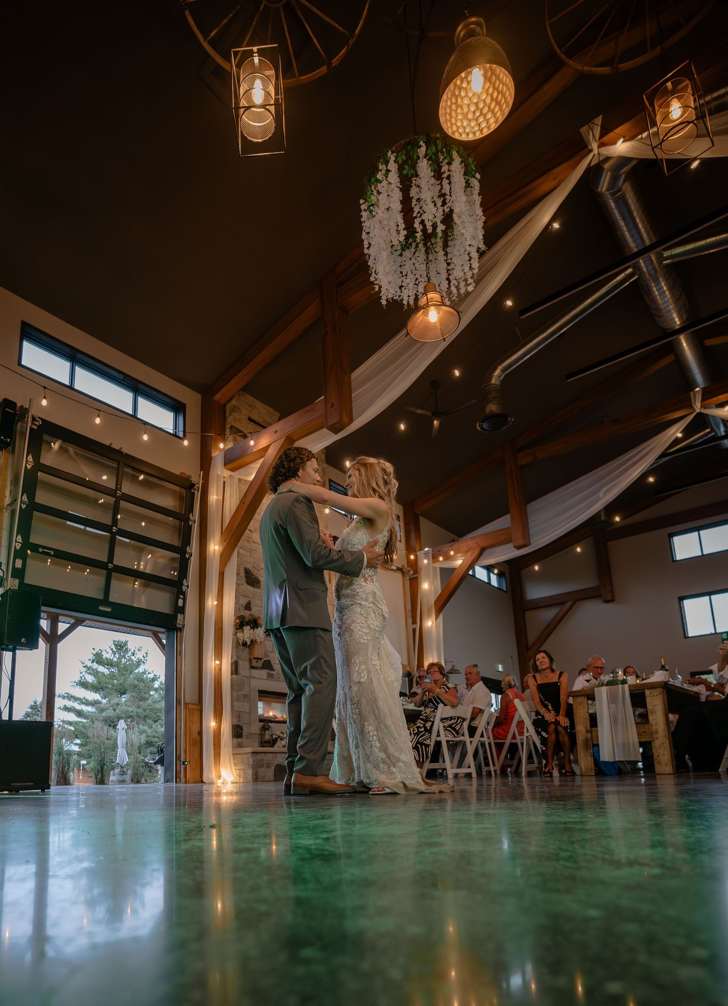 Modern wedding venue interior with dramatic lighting and high ceilings.