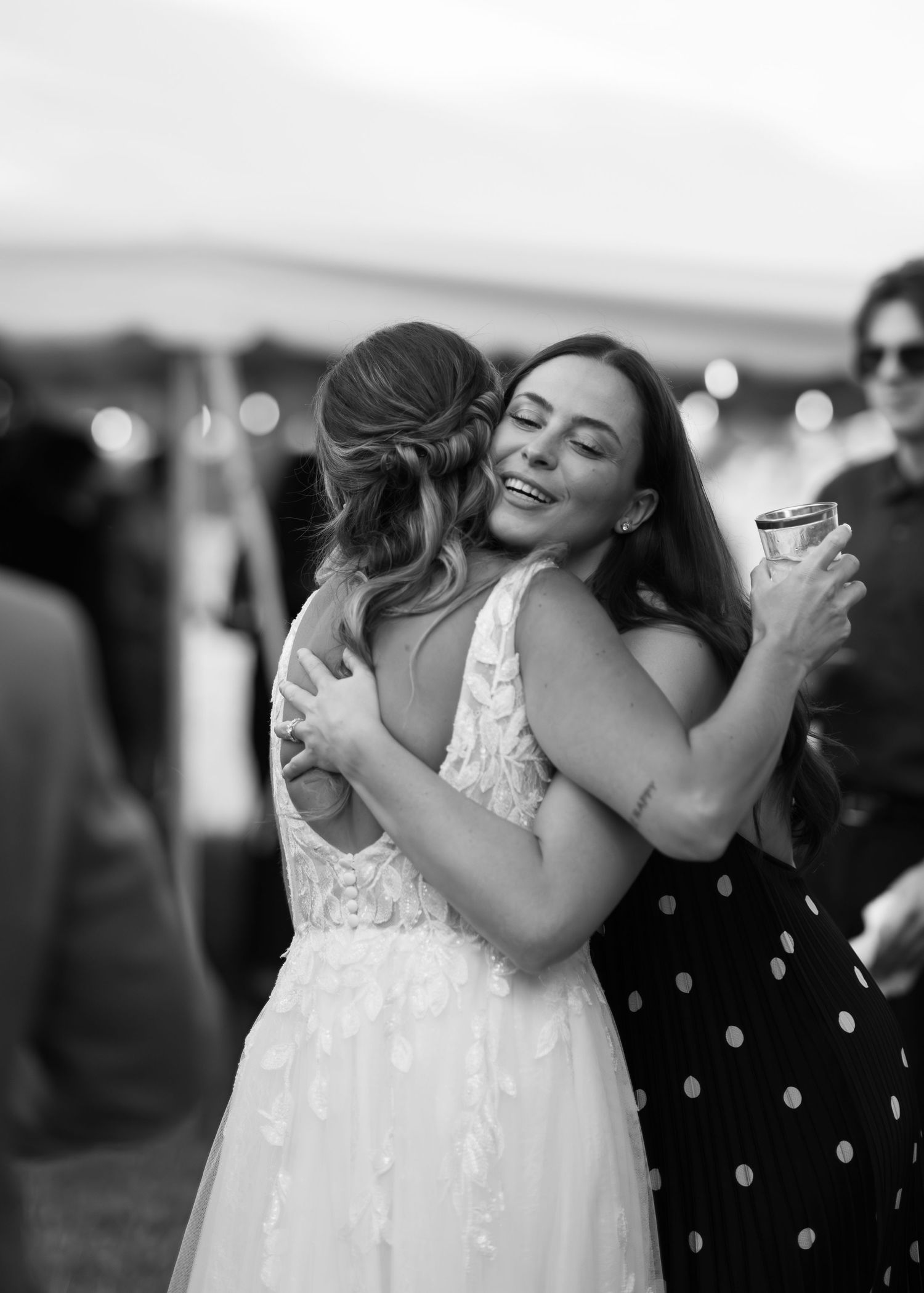 Black and white photo sequence showing emotional embraces between people at a wedding celebration.