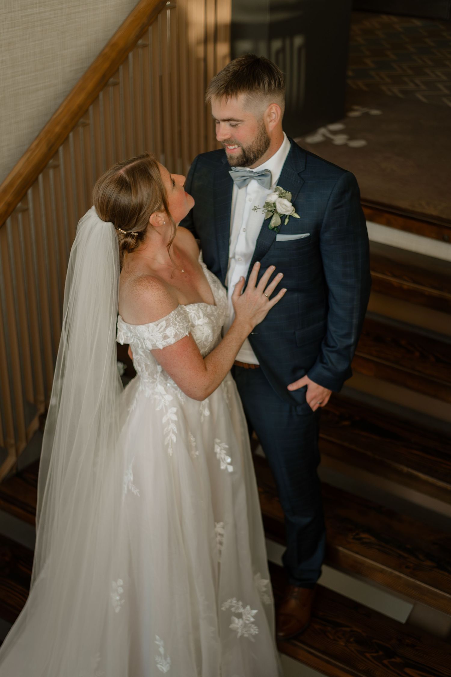 A couple shares their first kiss during an intimate indoor wedding ceremony.