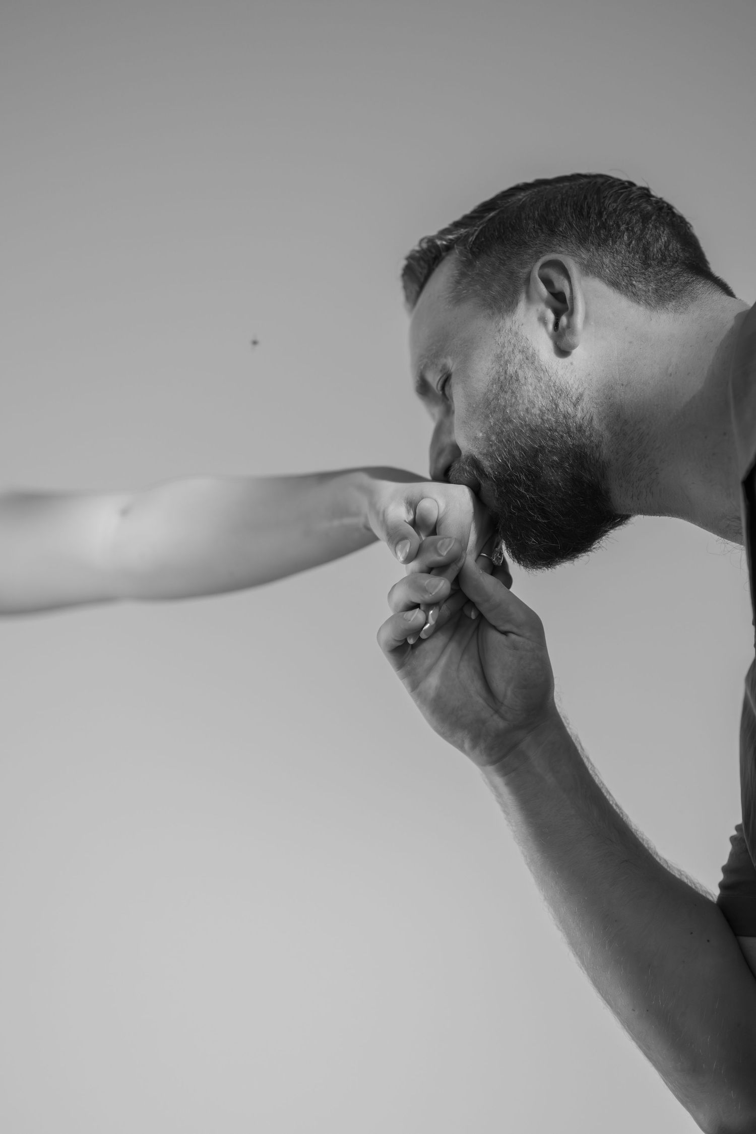 Artistic black and white shot of gentle hand gestures against minimal background.