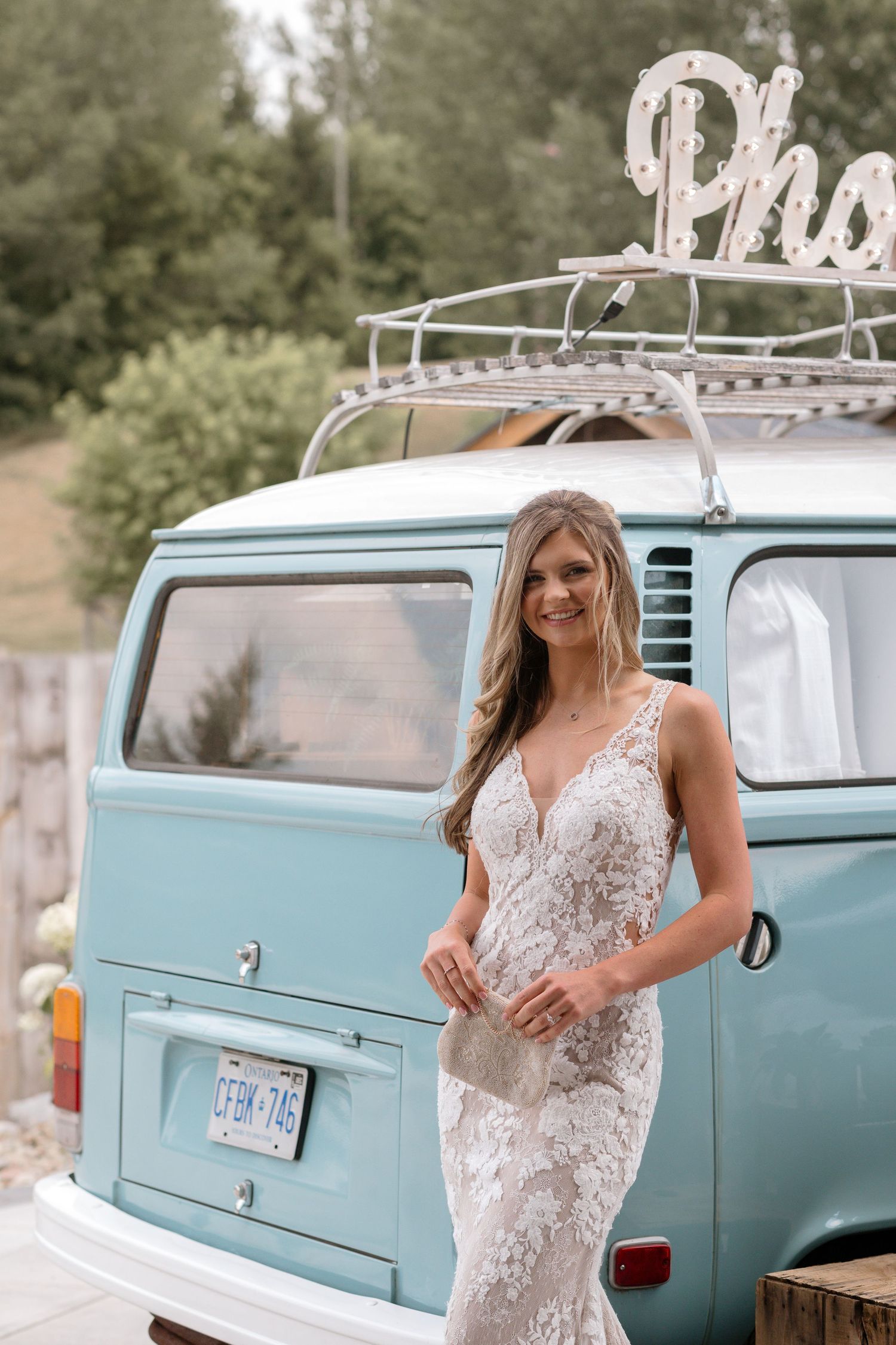 A vintage turquoise Volkswagen van decorated for a wedding celebration.