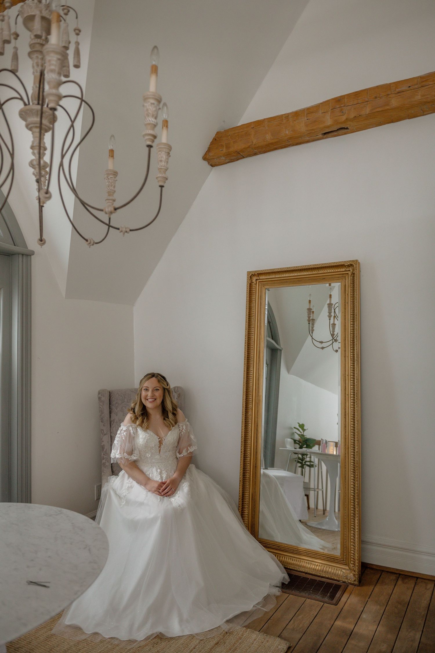 A series of bridal portraits showing a flowing white wedding gown in an elegant room with gold-framed mirrors and chandeliers.