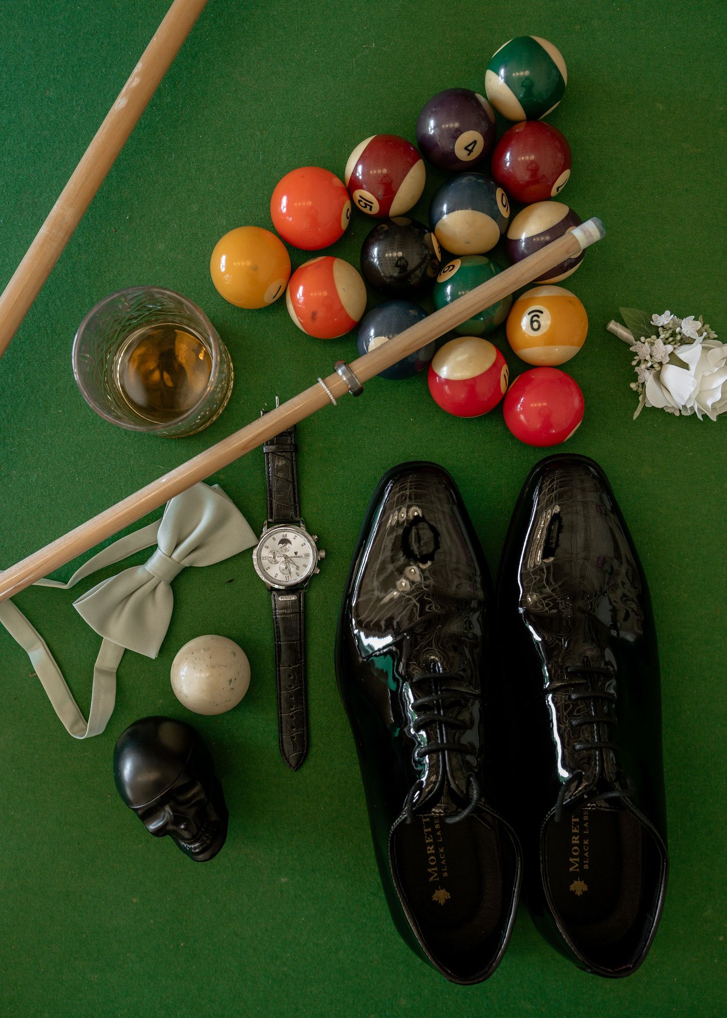 Vintage bowling shoes and billiard balls arranged on green felt with chalk and cue sticks in a collage composition.