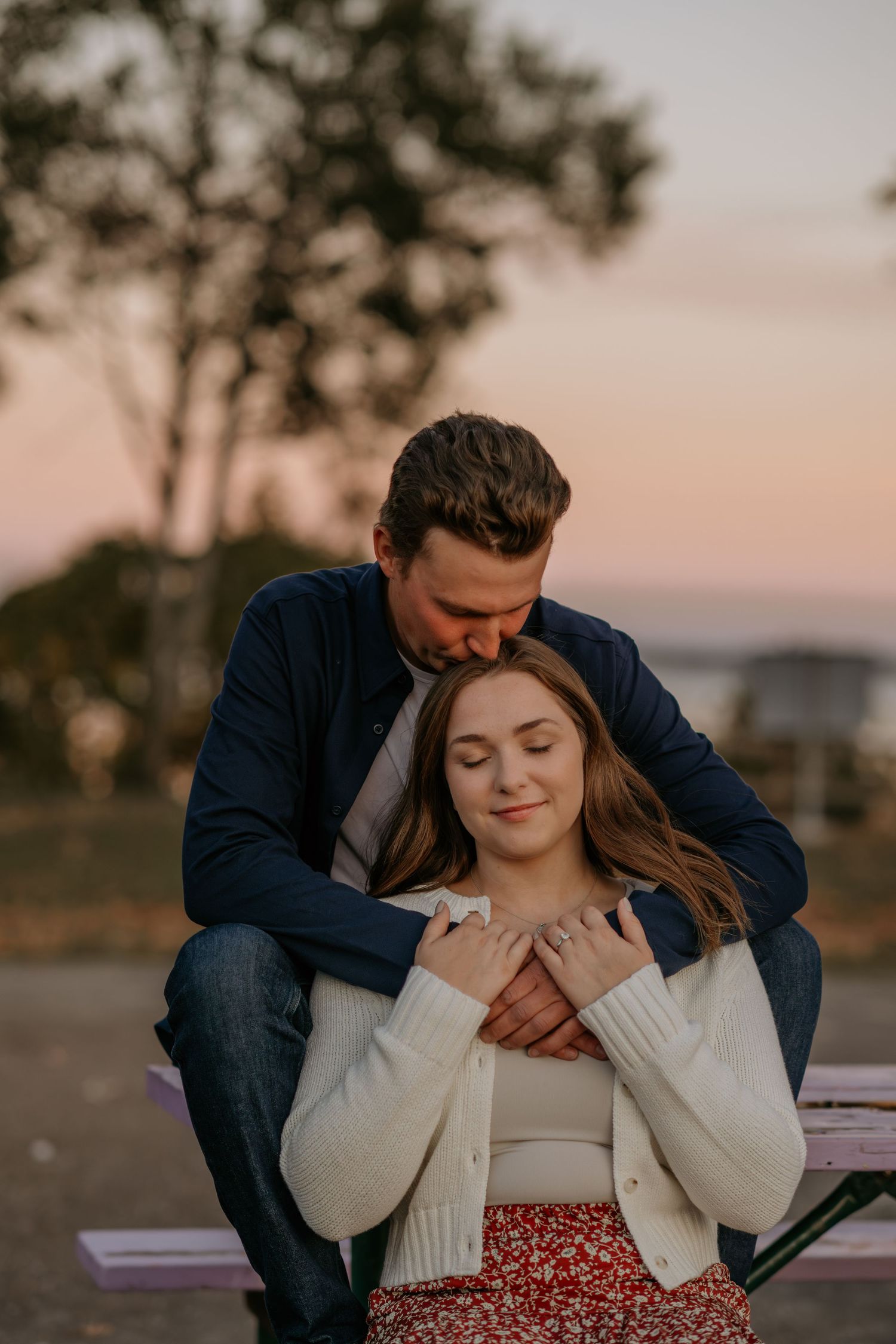 Tender moment shared between couple during sunset photoshoot.