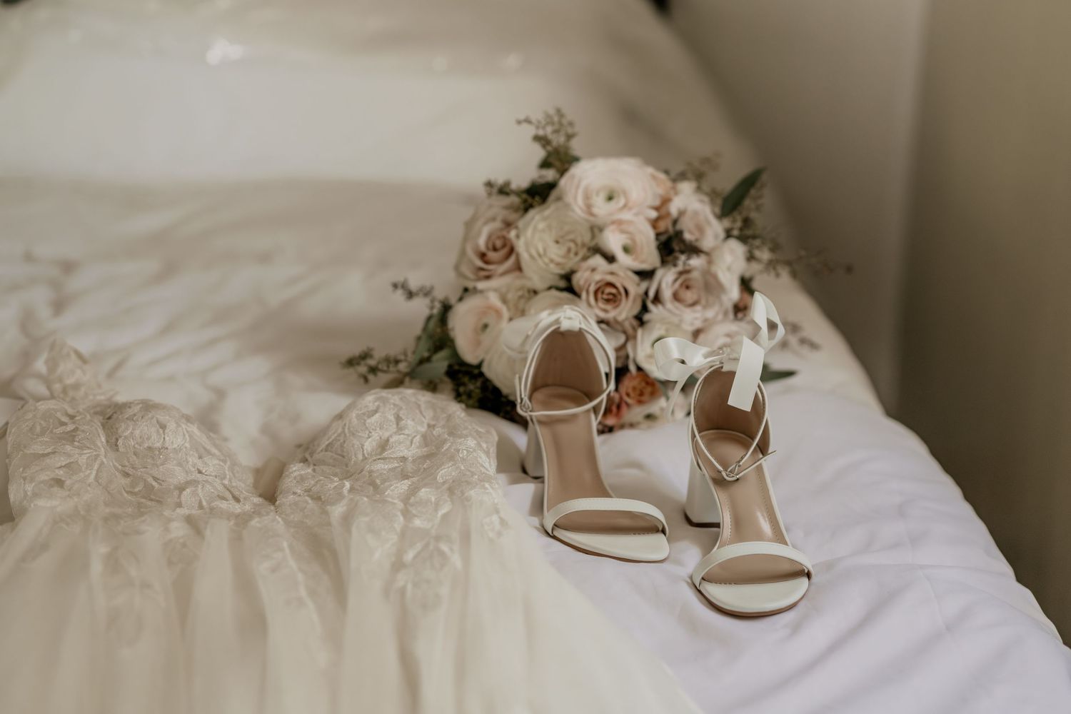 A collage of elegant wedding details including bridal shoes, floral arrangements, and delicate lace fabrics.