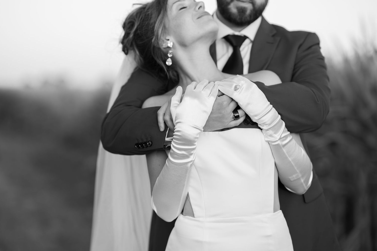 Romantic black and white portrait of a couple sharing an intimate moment during their wedding.