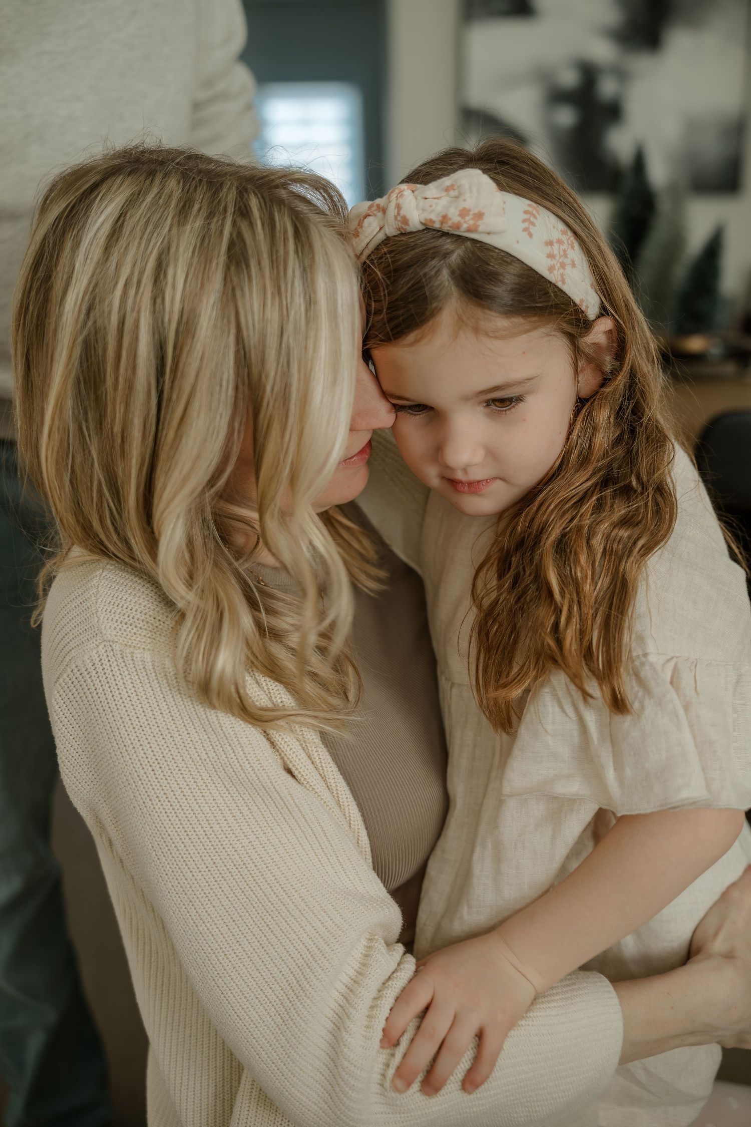 Two people sharing an intimate embrace while wearing light colored clothing.