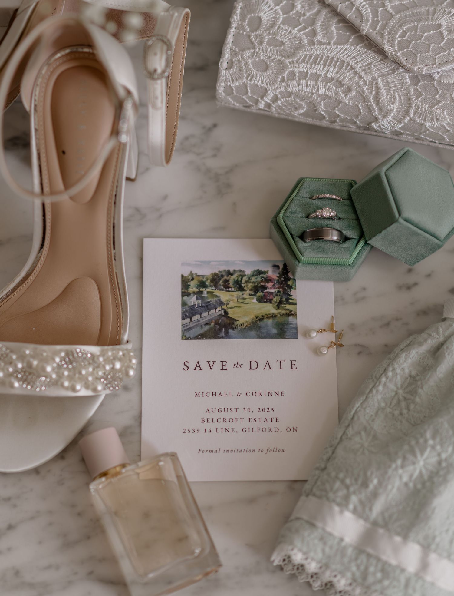 Wedding invitation suite with save the date cards, envelopes, and delicate lace details in soft neutral colors.