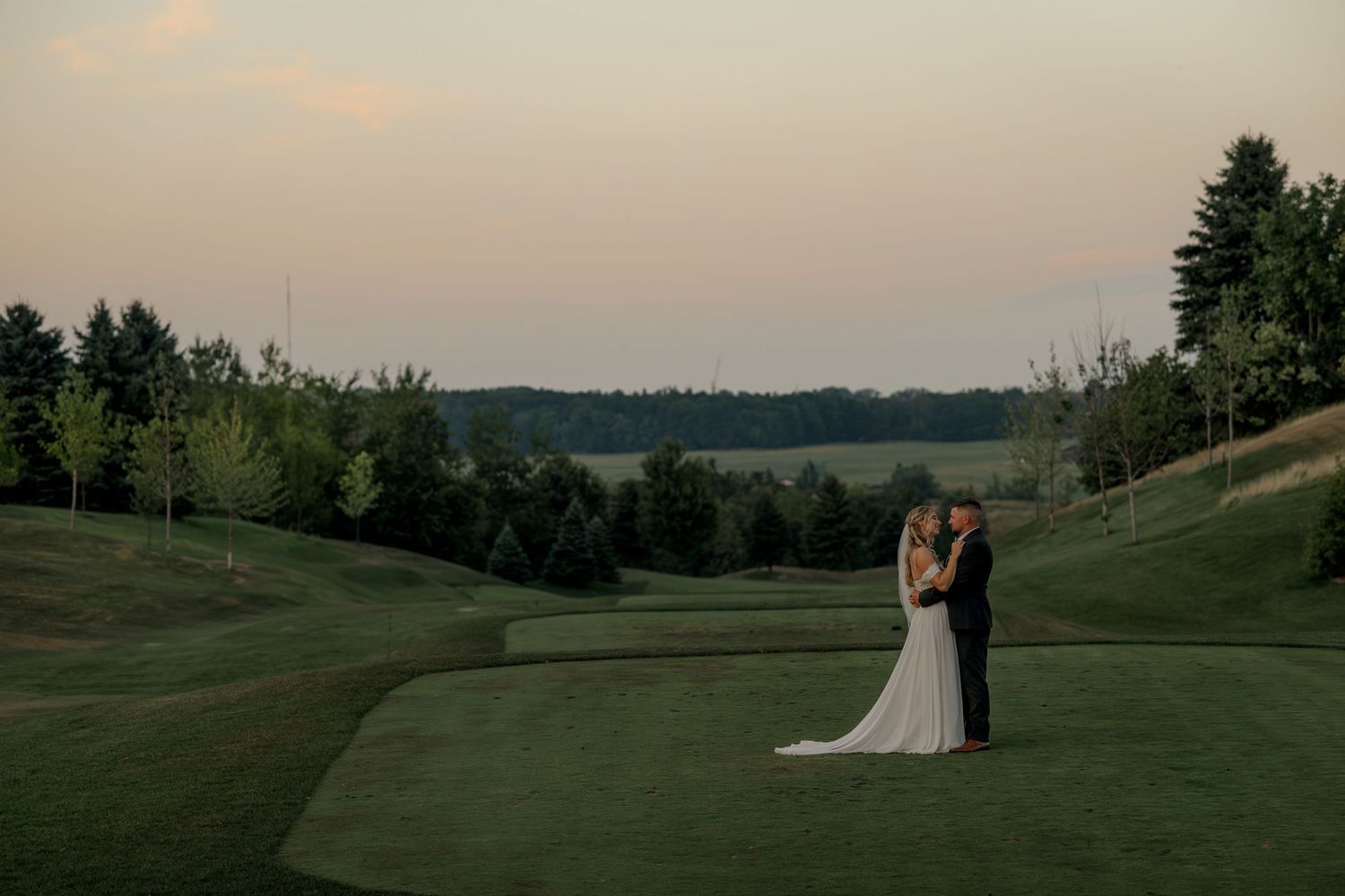 Panoramic view of a golf course wedding venue at dusk.