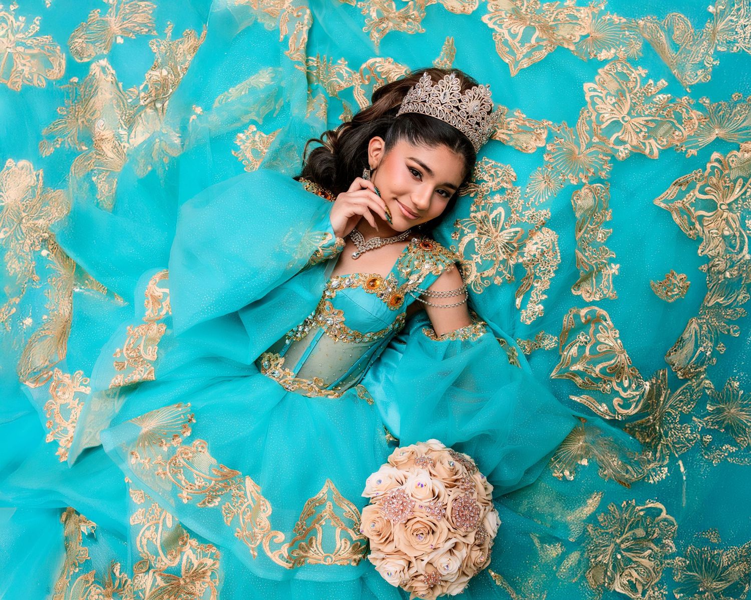 Sweet 16 photo session Young girl in turquoise quinceañera gown with gold embroidery, crown. Princess Jasmine inspired Photo Session