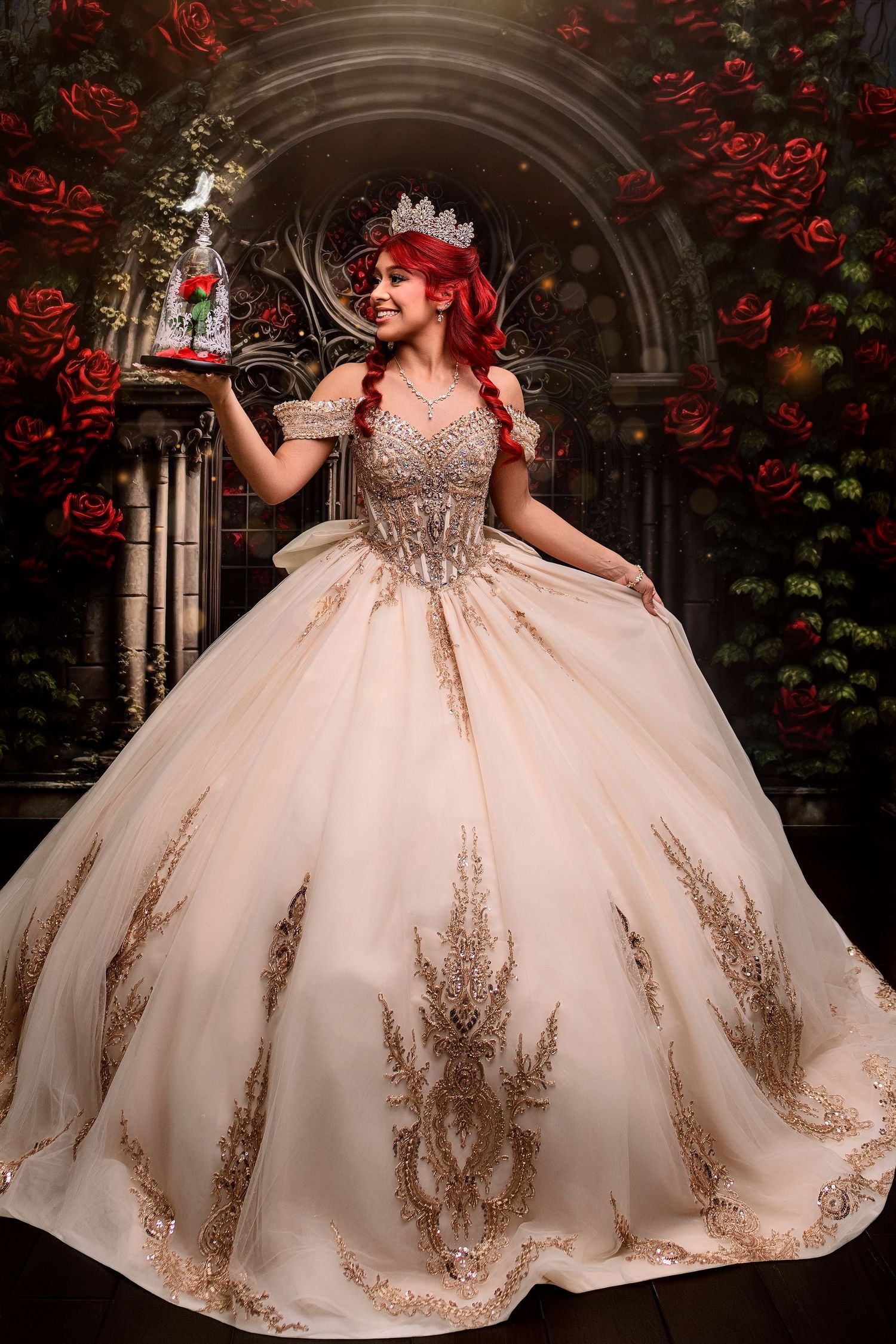 Woman in gold ball gown with crown holds enchanted rose, Beauty and the Beast inspired quinceañera photo.
