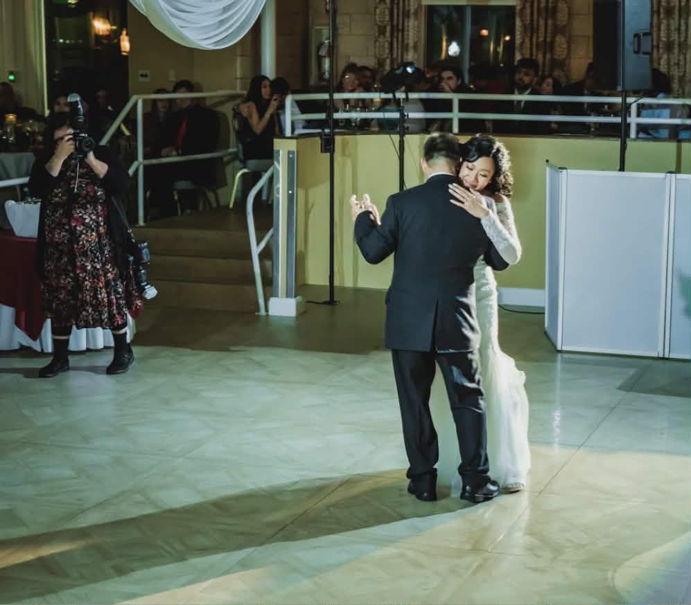 Bride and groom share their first dance at a wedding reception while Claudia Ruiz (Raven) form taken by raven captures the moment.