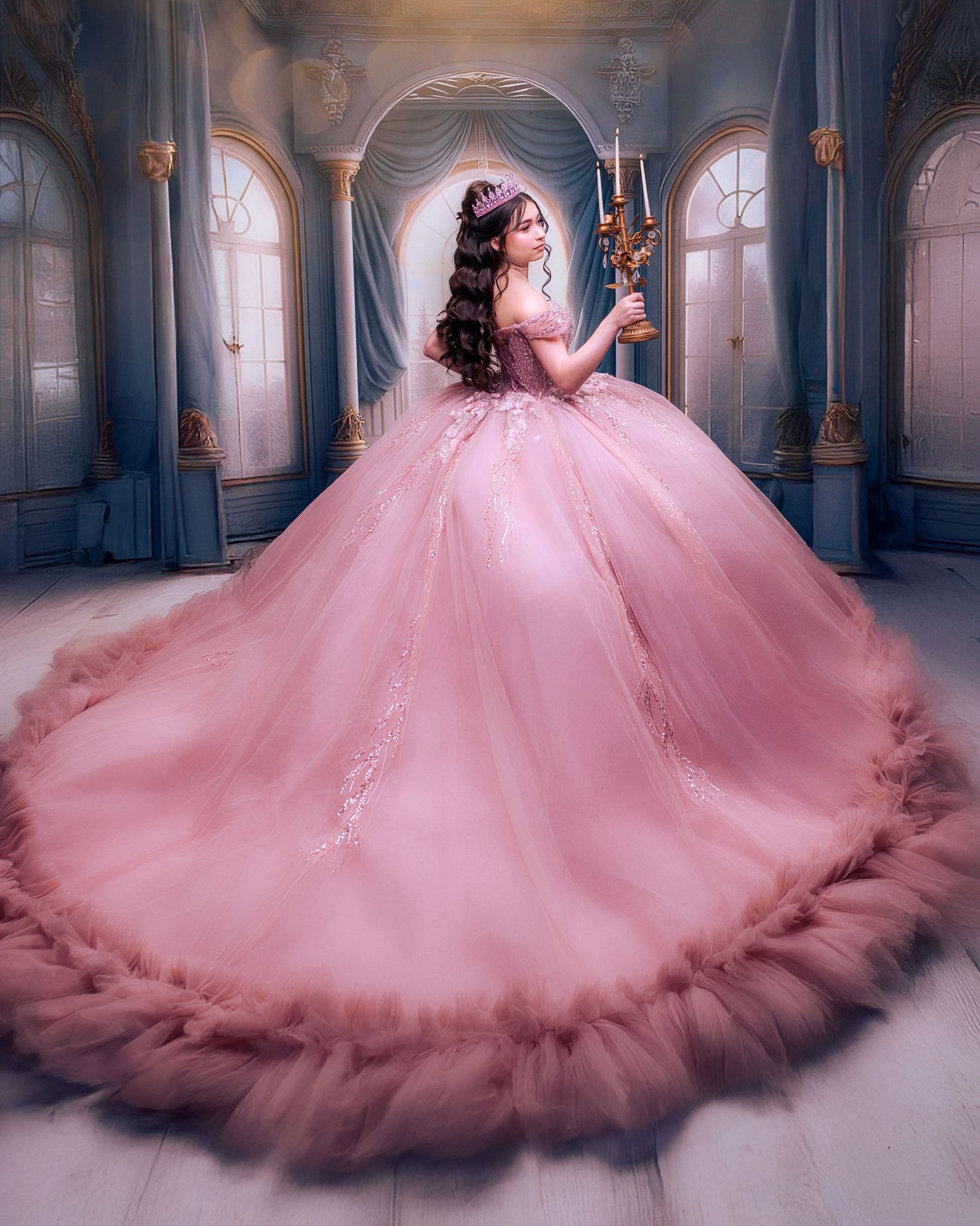 Young woman in a stunning pink ball gown with tiara holds candelabra in an elegant fairy-tale palace setting.