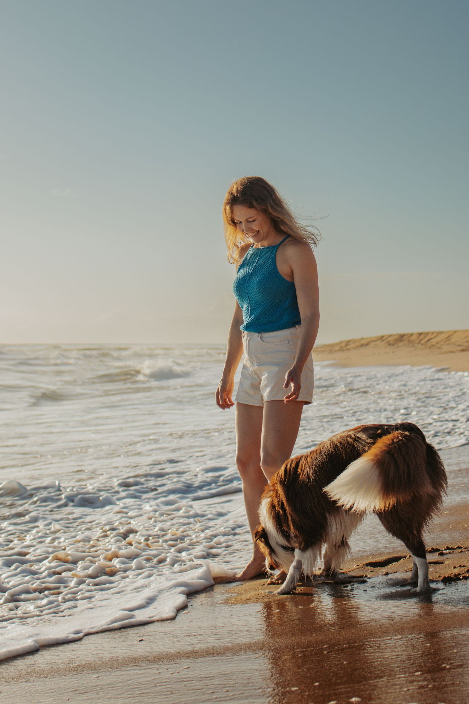 woman and her dog at the beach