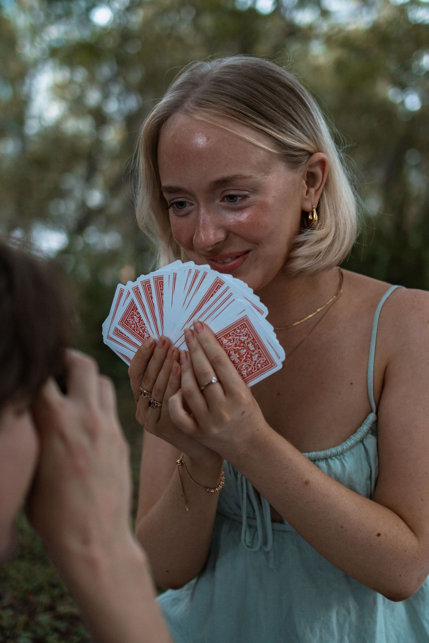 couple playing cards in the park