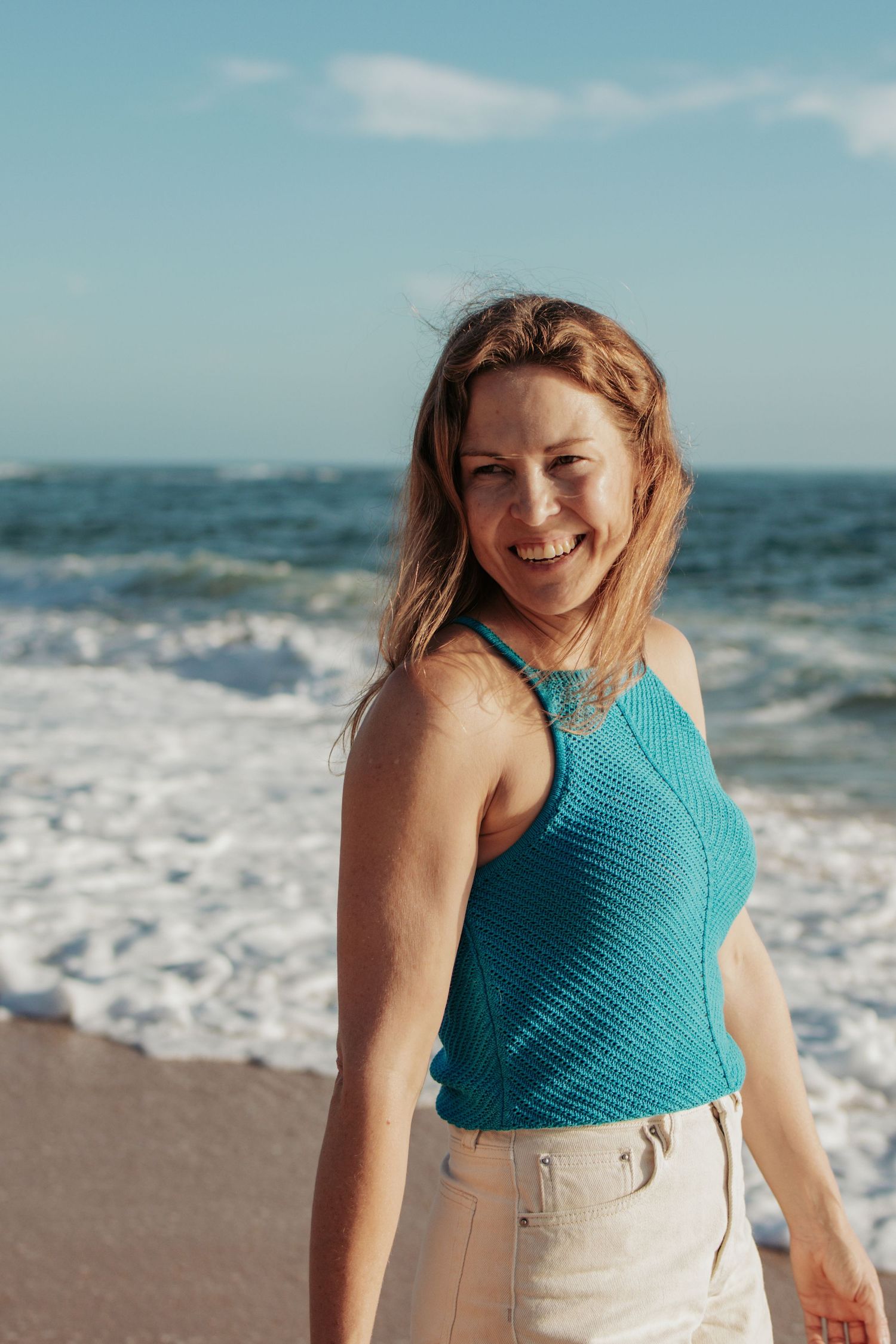 woman in a blue top at the beach
