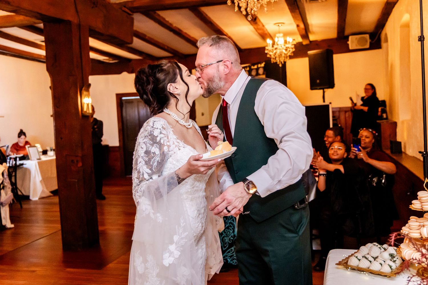 A romantic first dance moment in a rustic venue with wooden beams and warm lighting.
