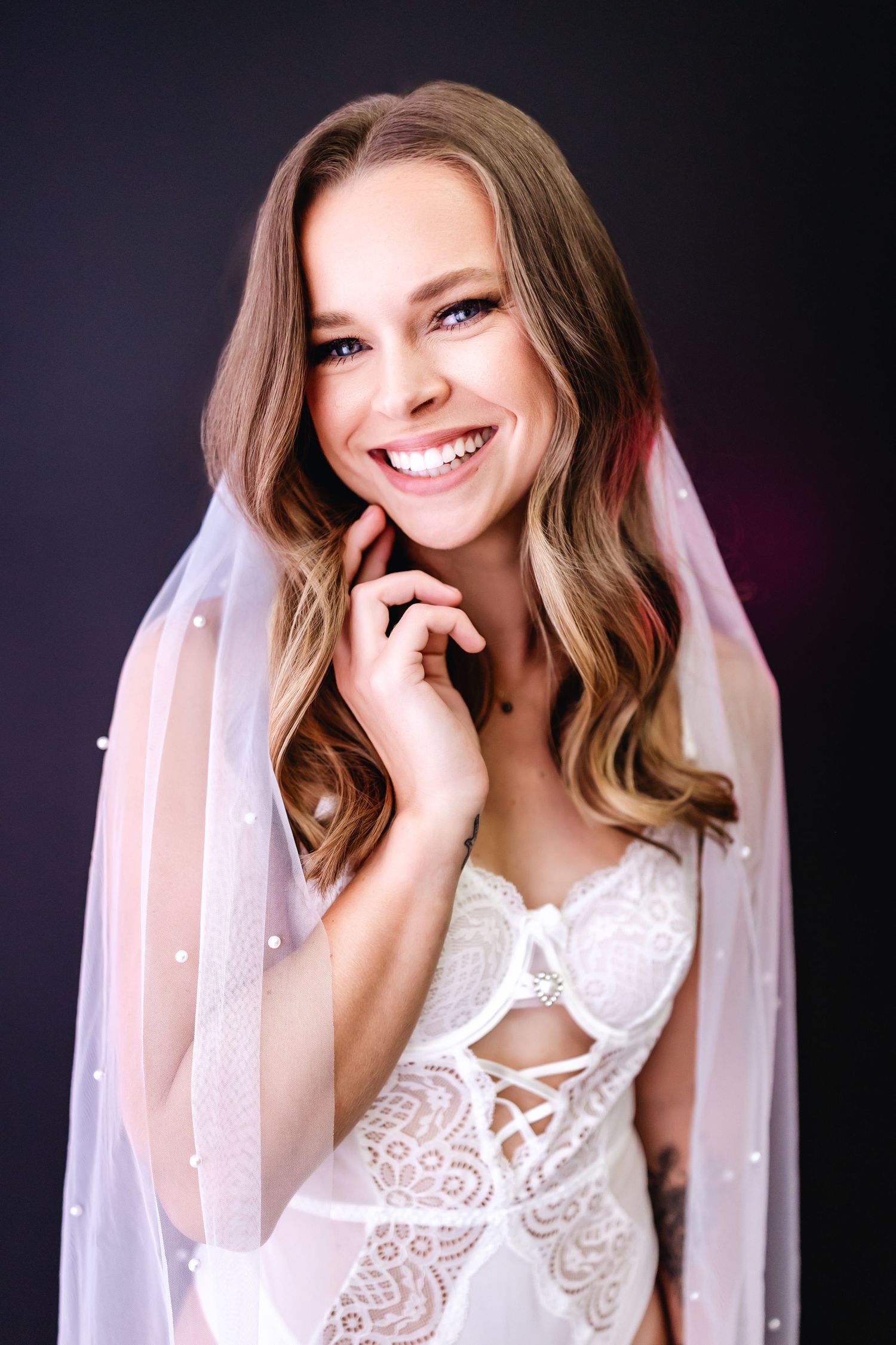 A series of glamour portraits showing someone in a white lace dress and veil against a dark background.