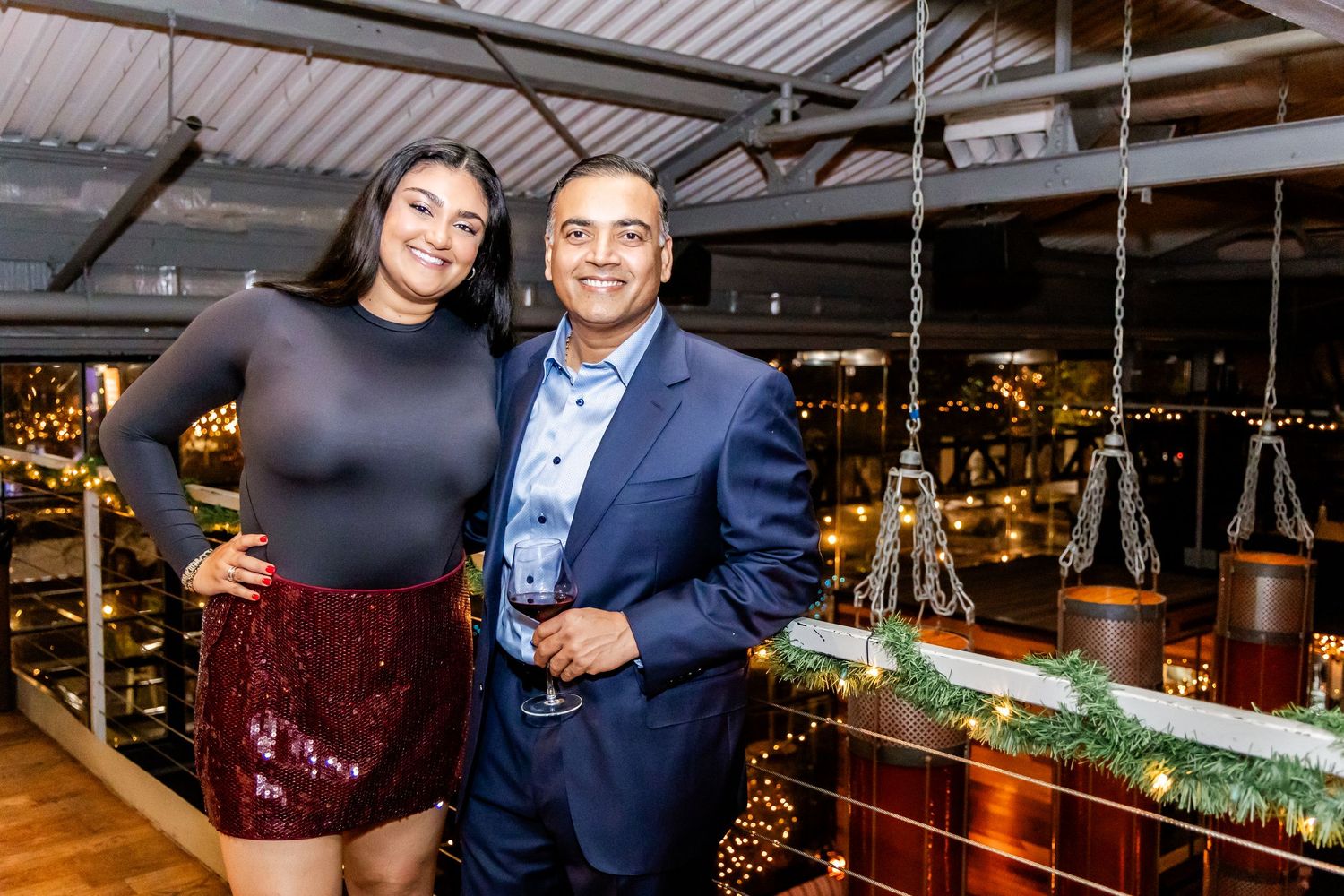 Evening social gathering in an upscale venue with decorative lighting.