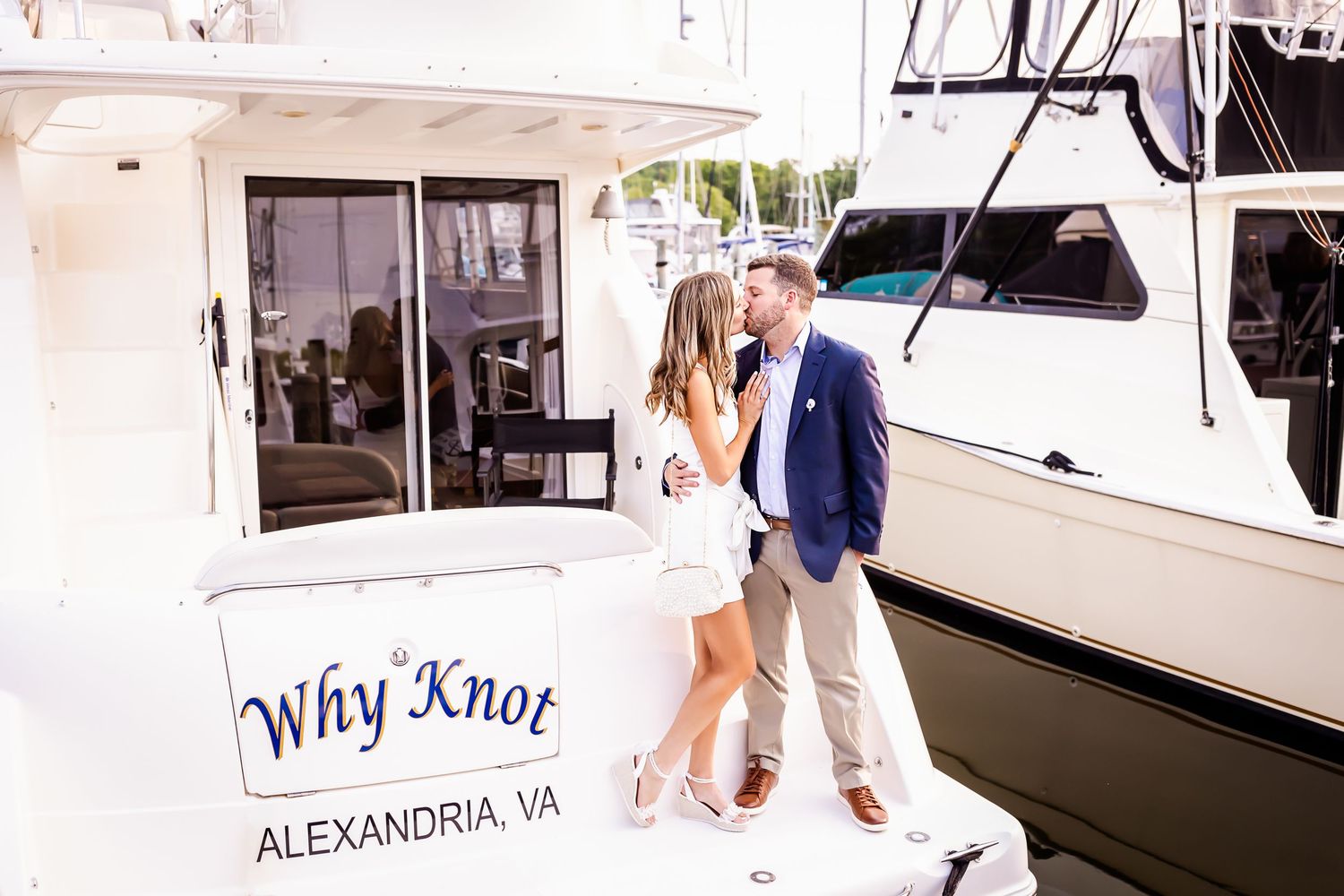A couple poses together on their boat named 'Why Knot' docked in Alexandria, VA.