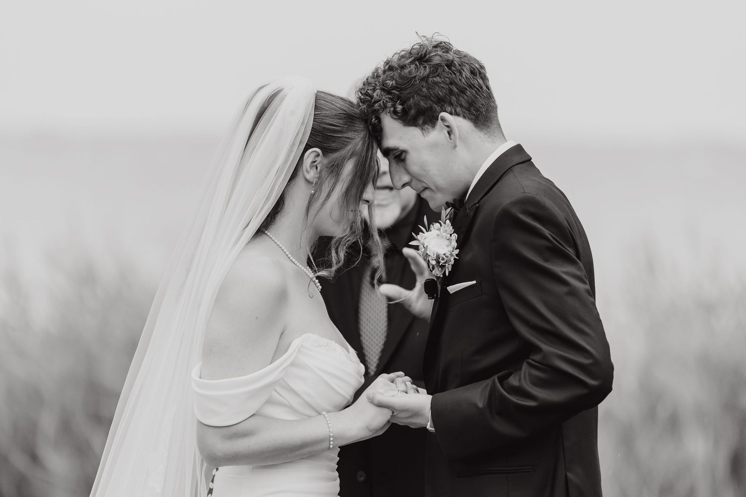 Black and white wedding portraits showing tender moments between newlyweds.