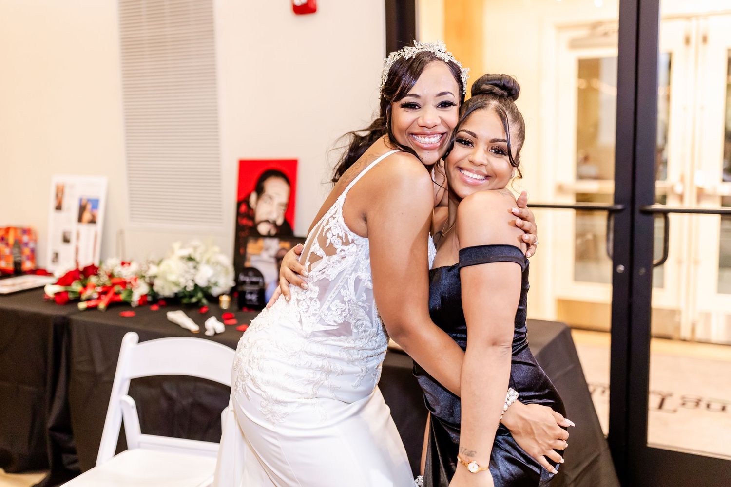 Two people sharing an embrace at an elegant indoor celebration.