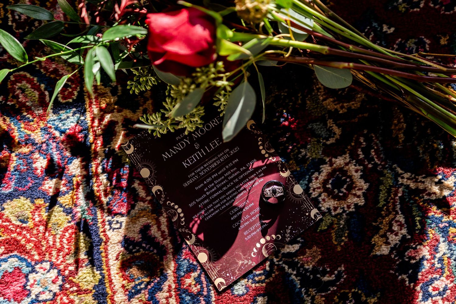 Colorful floral arrangements with red roses and greenery in artistic overhead composition.
