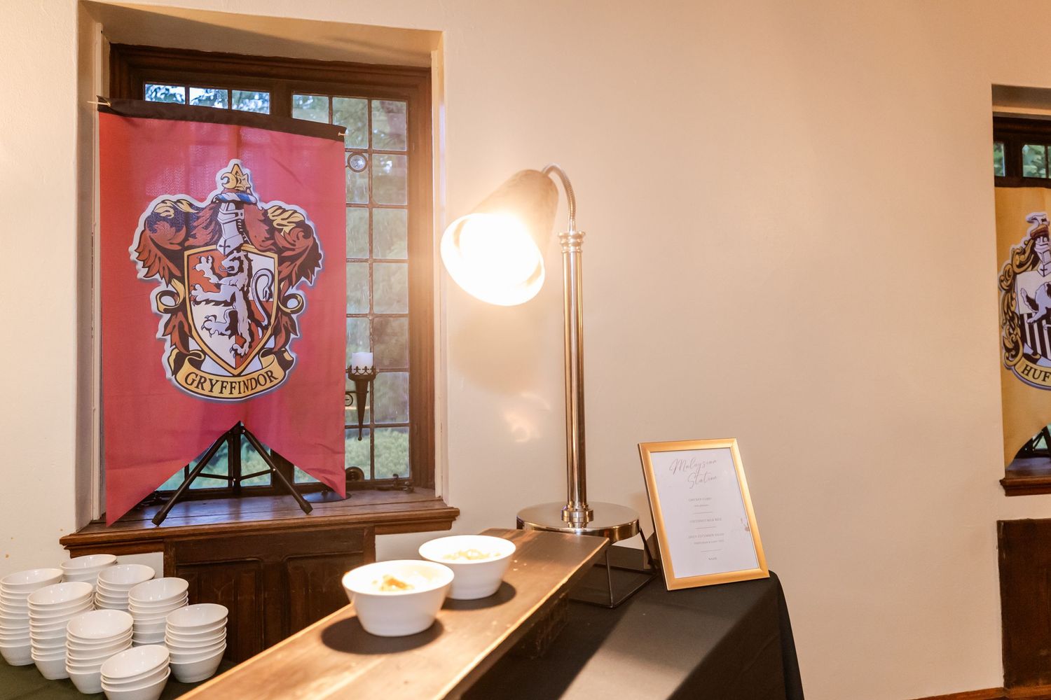 Harry Potter themed display with Gryffindor house banner and table settings.