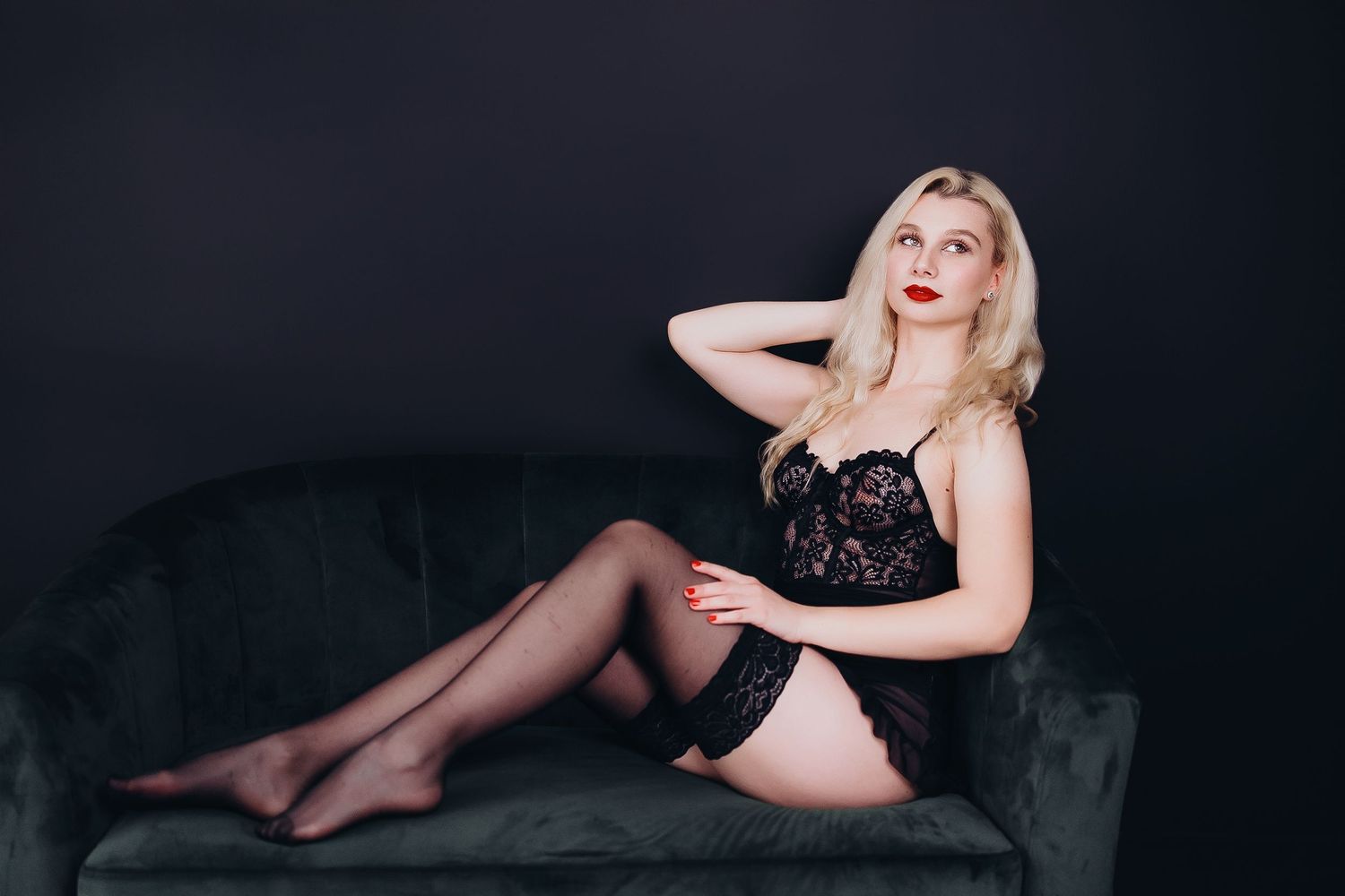 A glamorous boudoir photo series featuring dramatic lighting and elegant black lingerie against a dark background.