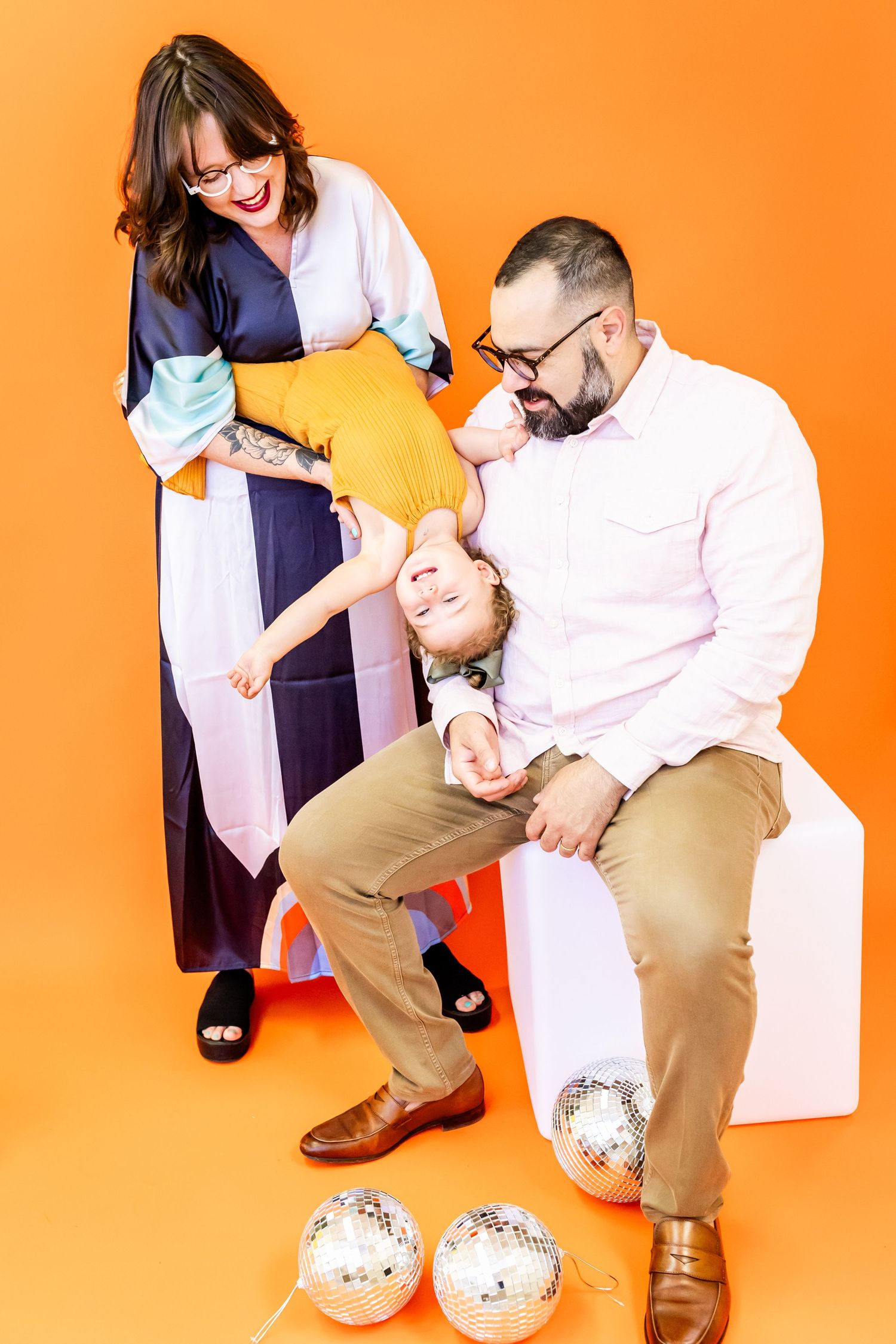 A series of photos showing a parent and child interacting and playing together against a bright orange background.