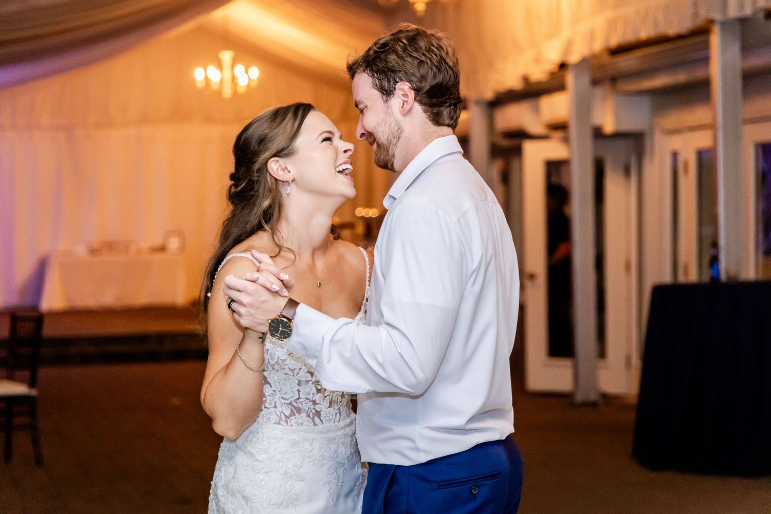 Couples sharing romantic dances at an indoor wedding reception with warm ambient lighting.