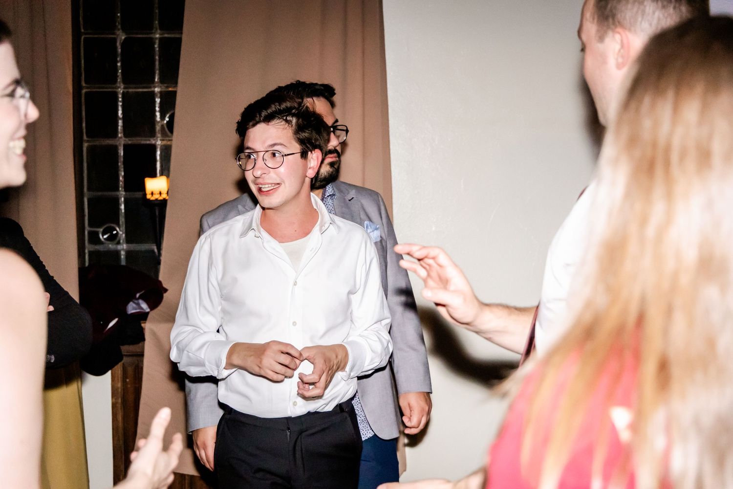 People socializing and dancing at an indoor event.