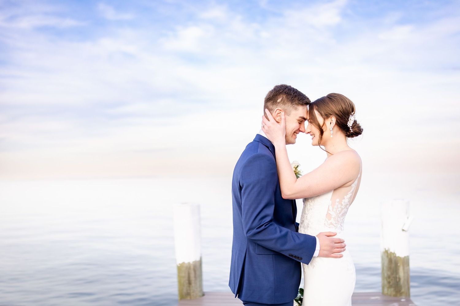 Romantic waterfront wedding portraits with ocean backdrop.