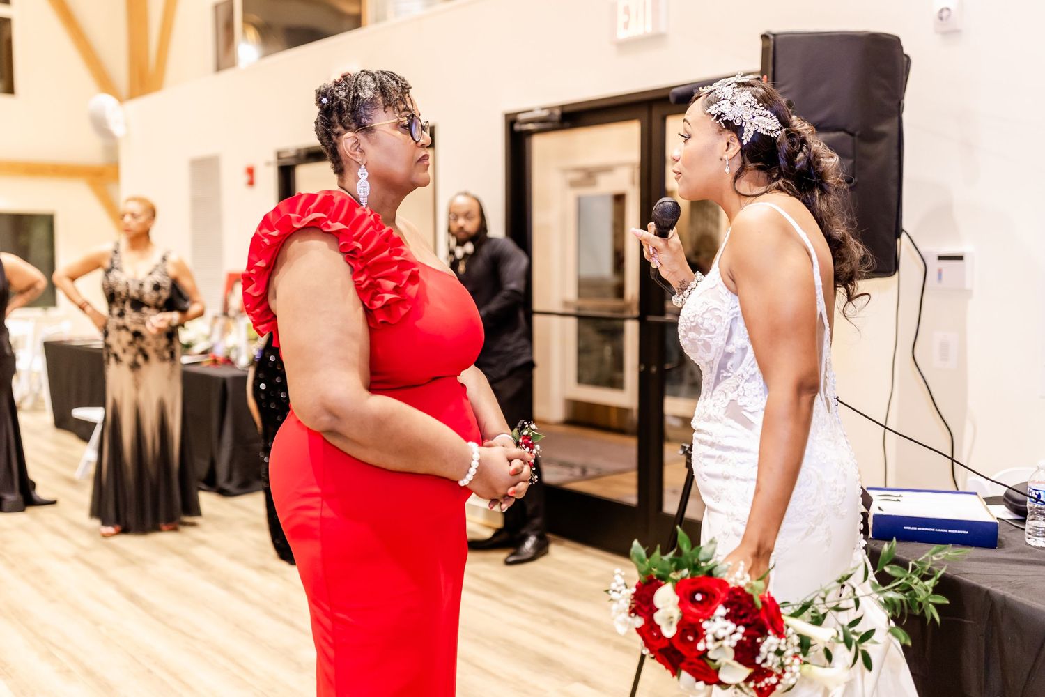 Emotional moment between two people at formal event with red and white color scheme.