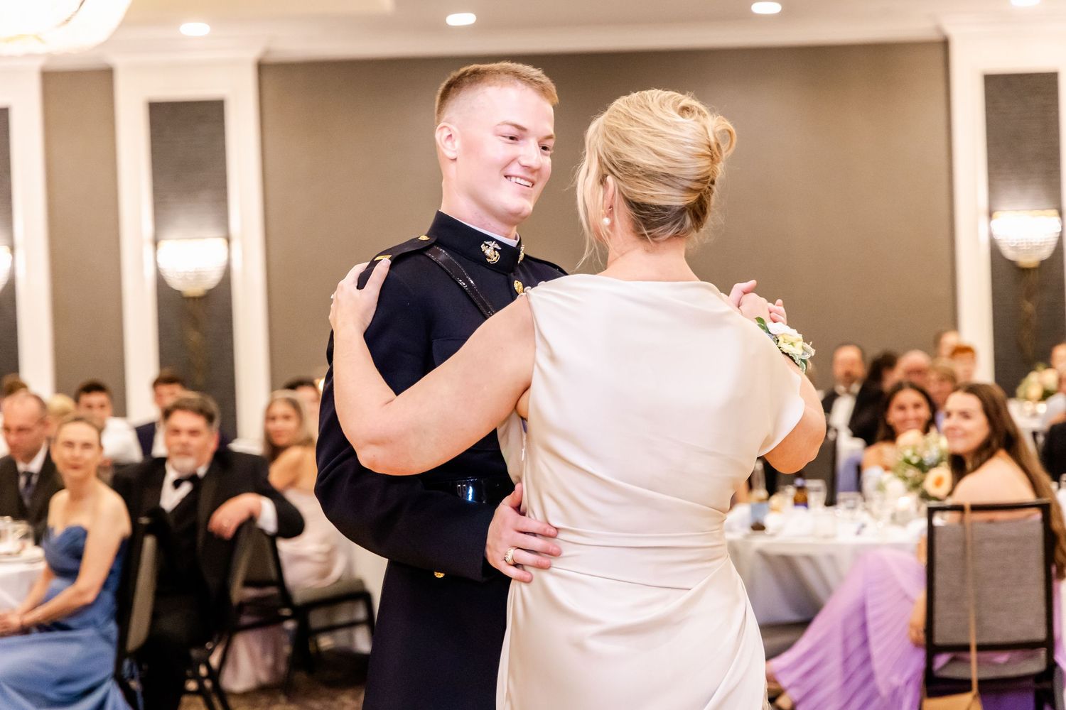 Couples dancing together during an elegant wedding reception in a grand ballroom.