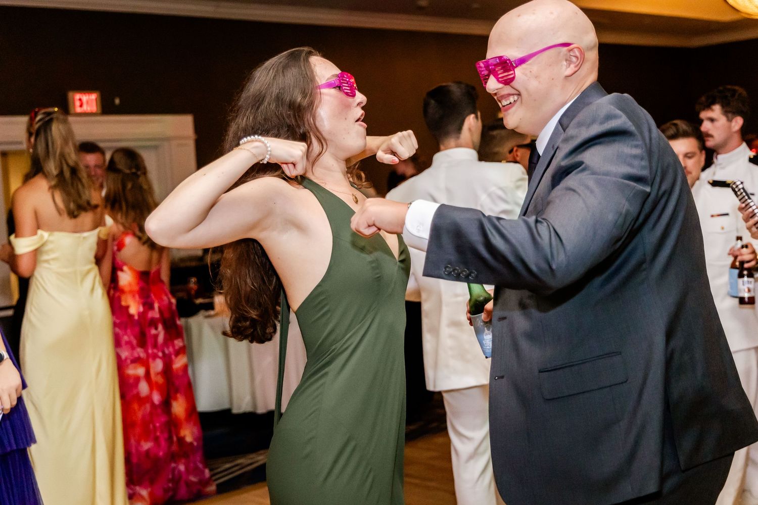 Wedding guests dancing and enjoying themselves at an indoor reception.