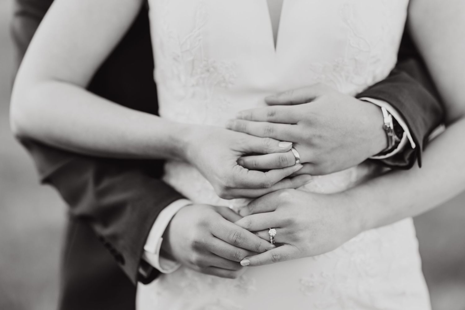 Close-up black and white detail shots of wedding rings and hands.