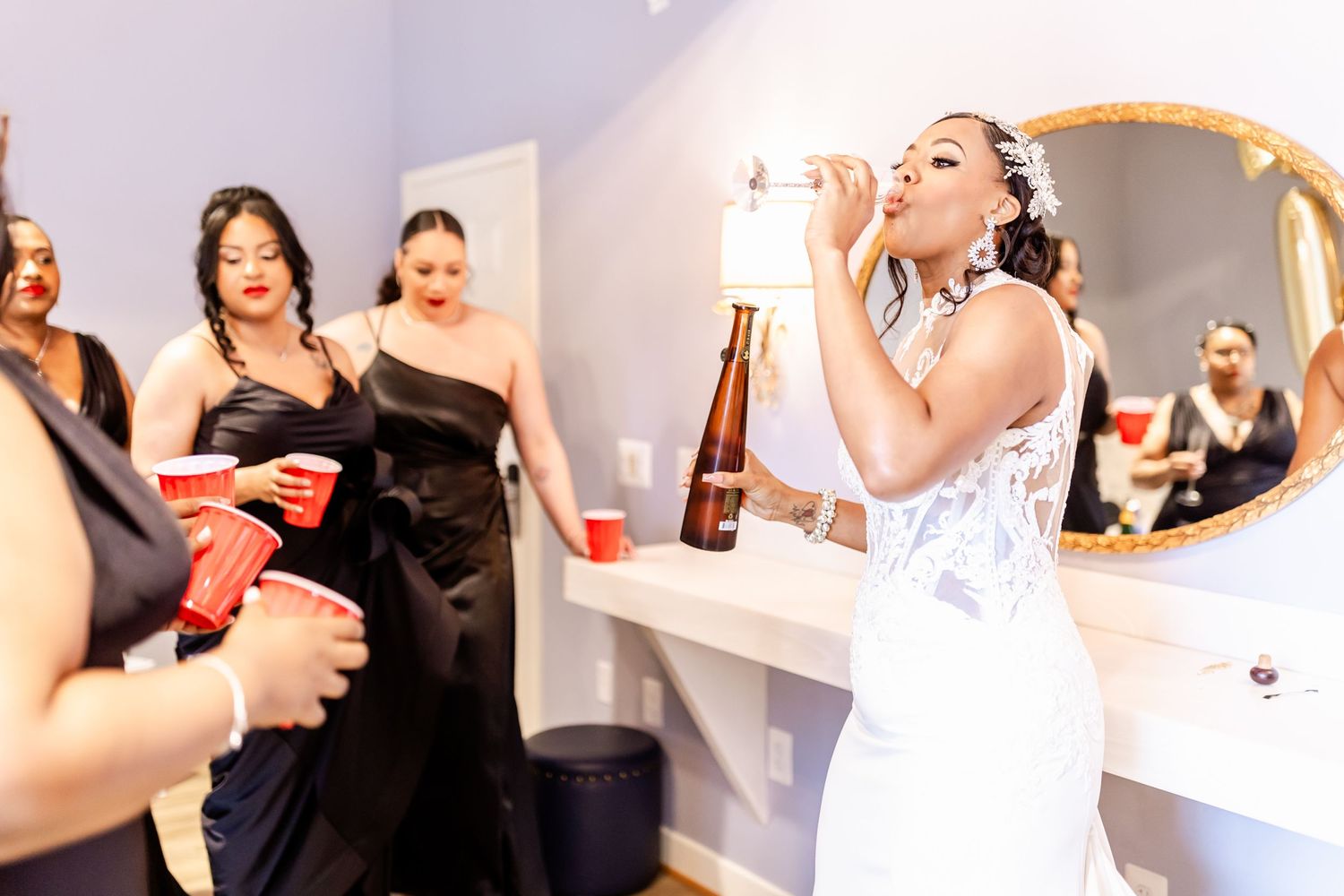Wedding celebration scene in a bridal preparation room with festive drinks.