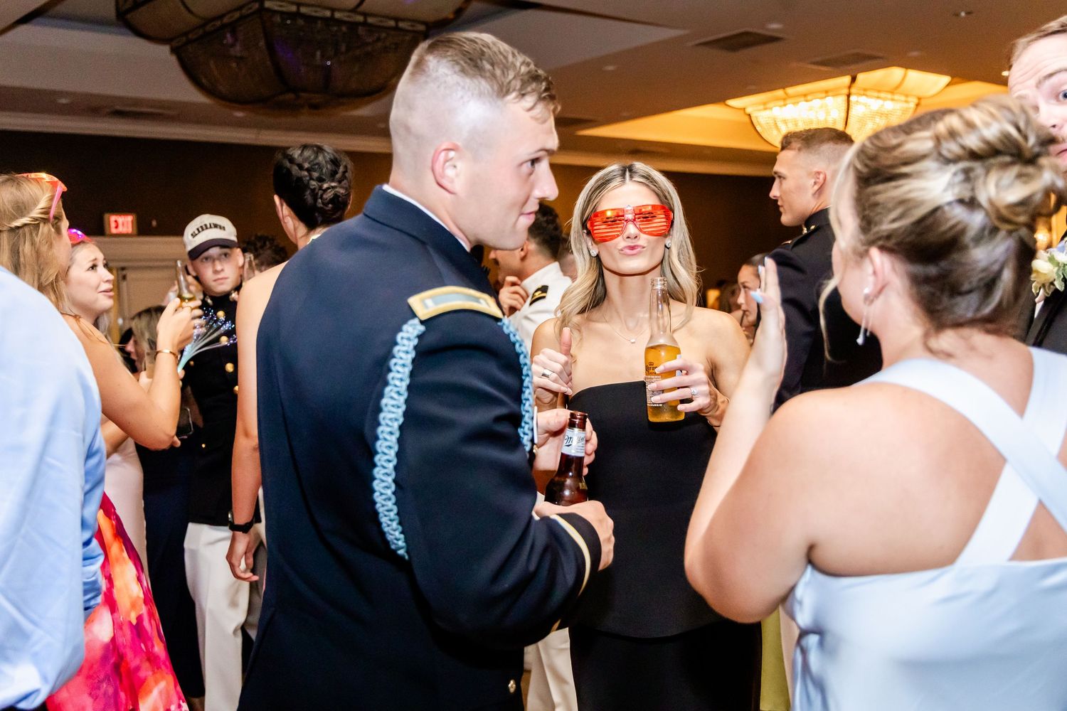 Wedding reception dance floor filled with celebrating guests in formal attire.