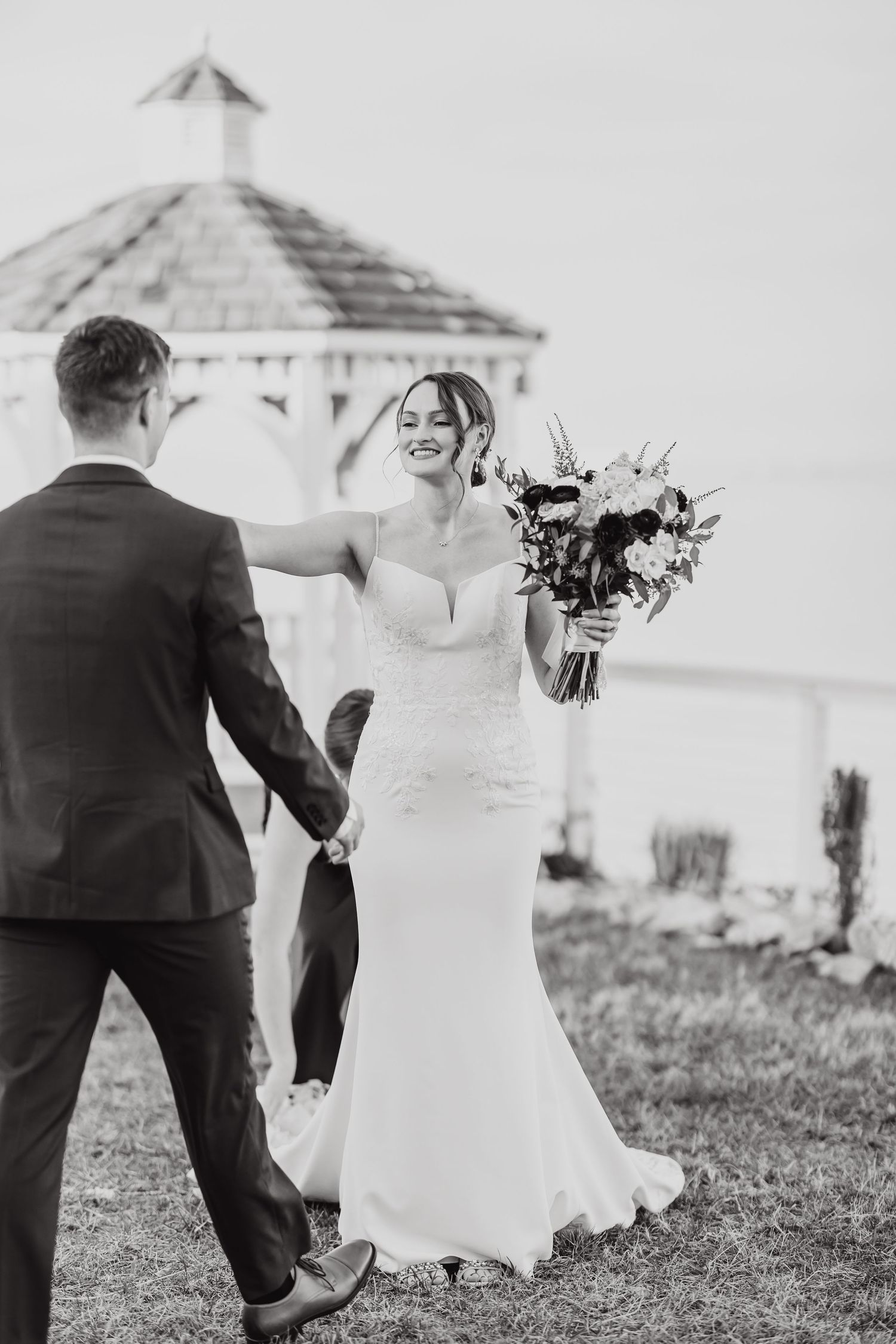 Black and white wedding photos captured near outdoor gazebo.