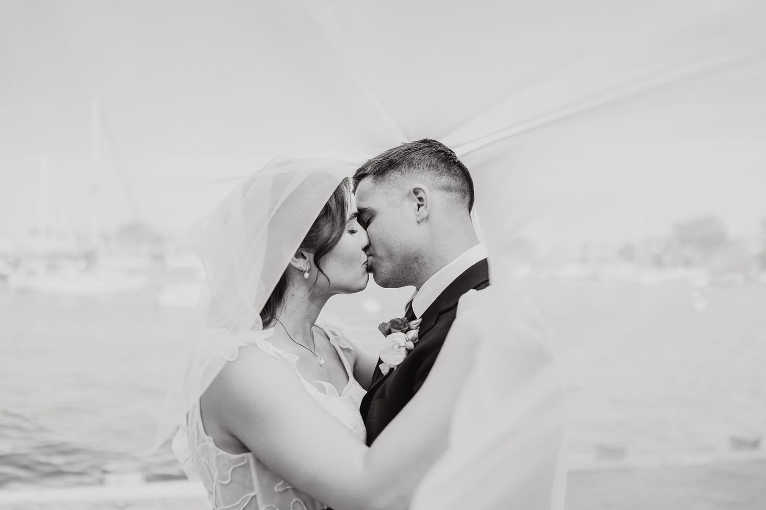 Intimate black and white portrait captures romantic wedding moment.