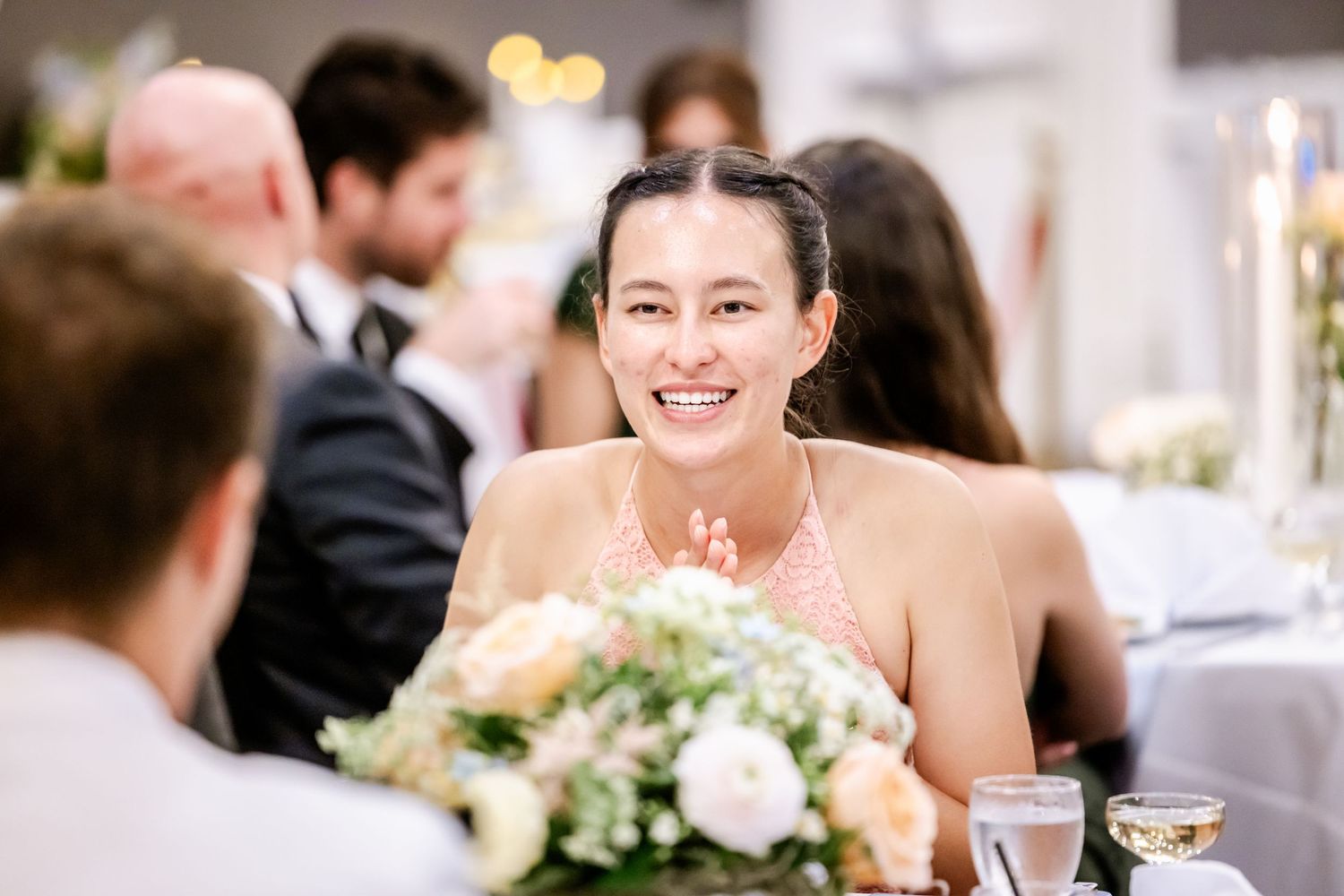 Wedding reception guests dancing and celebrating together on the dance floor at an elegant indoor venue.
