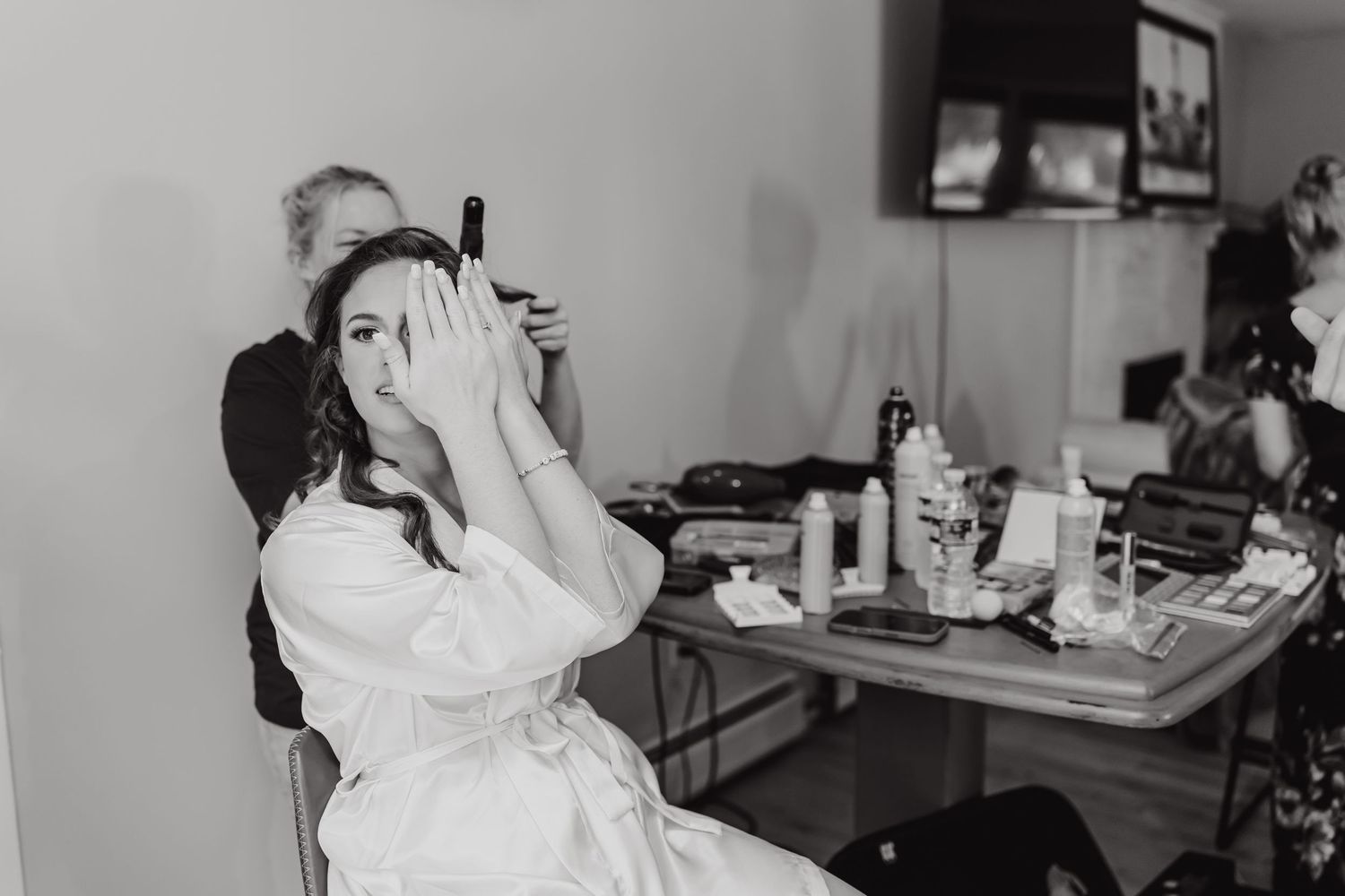 Black and white candid moments during wedding day preparations.