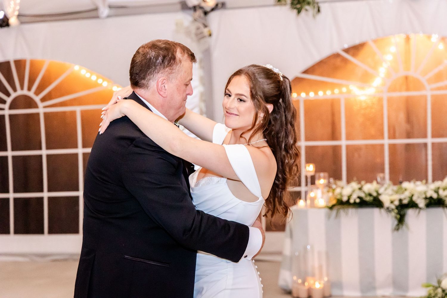 Wedding couples share dances with parents during an indoor reception.