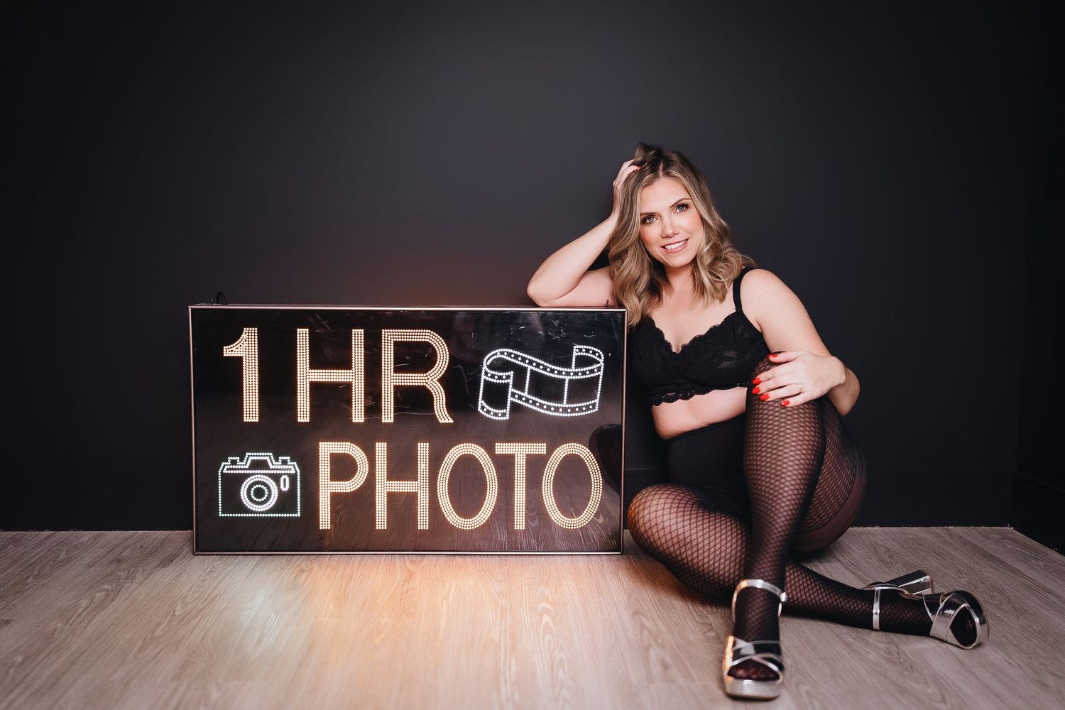 Black and white artistic boudoir photography session with dramatic lighting and shadows.