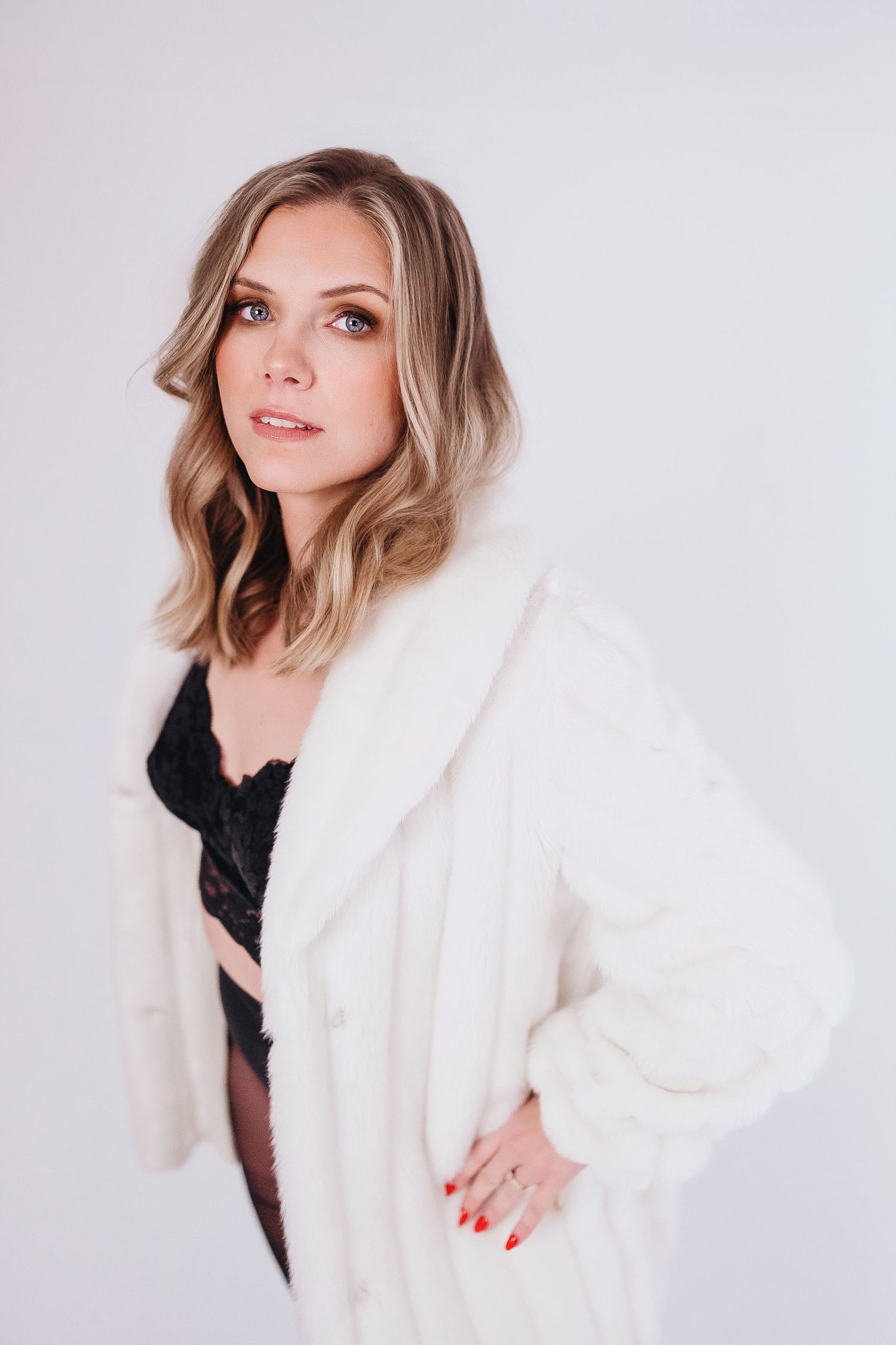 A series of four fashion portraits showing a model in a luxurious white fur coat against a light background.