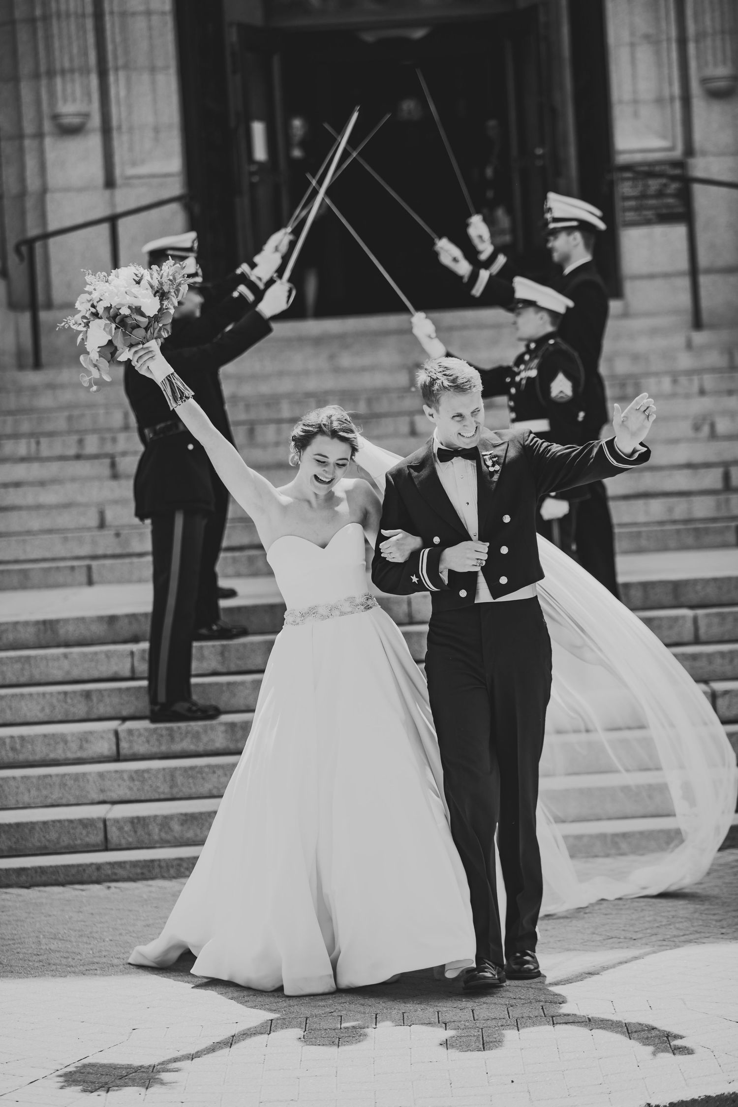 A sequence of black and white photos showing a wedding party posing on stone steps with flowing dresses and military uniforms.
