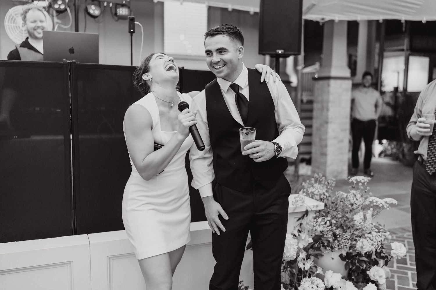 A series of black and white wedding photos showing candid moments and celebrations between couples and guests.