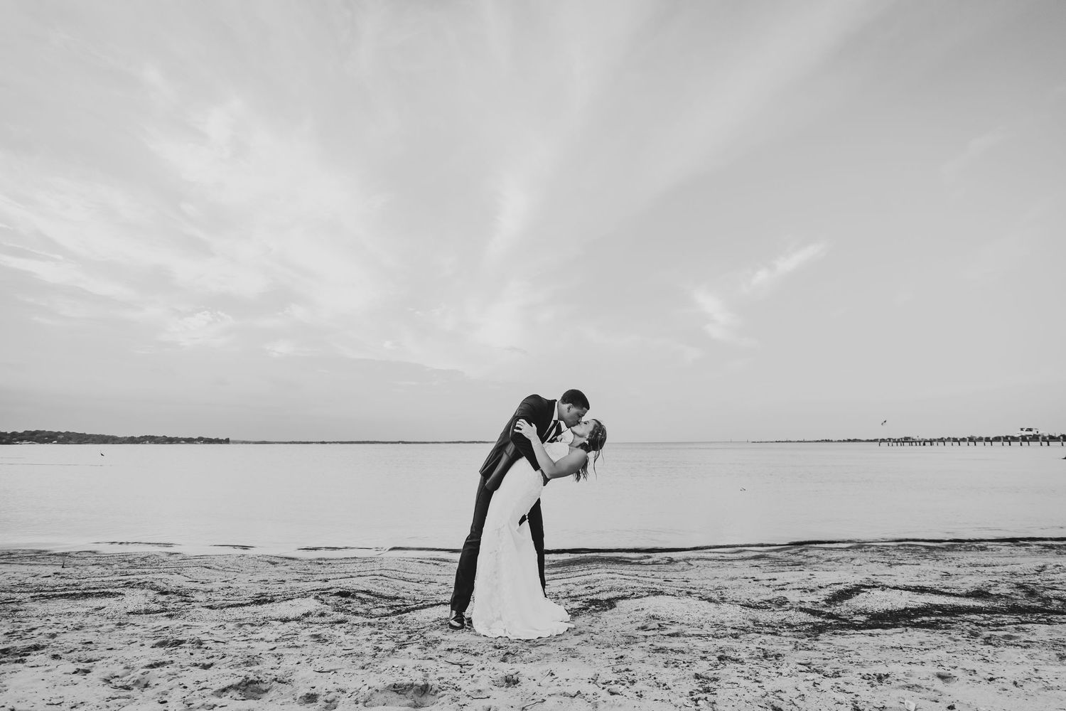 A series of romantic black and white beach wedding photos showing couples silhouetted against a dramatic ocean backdrop.